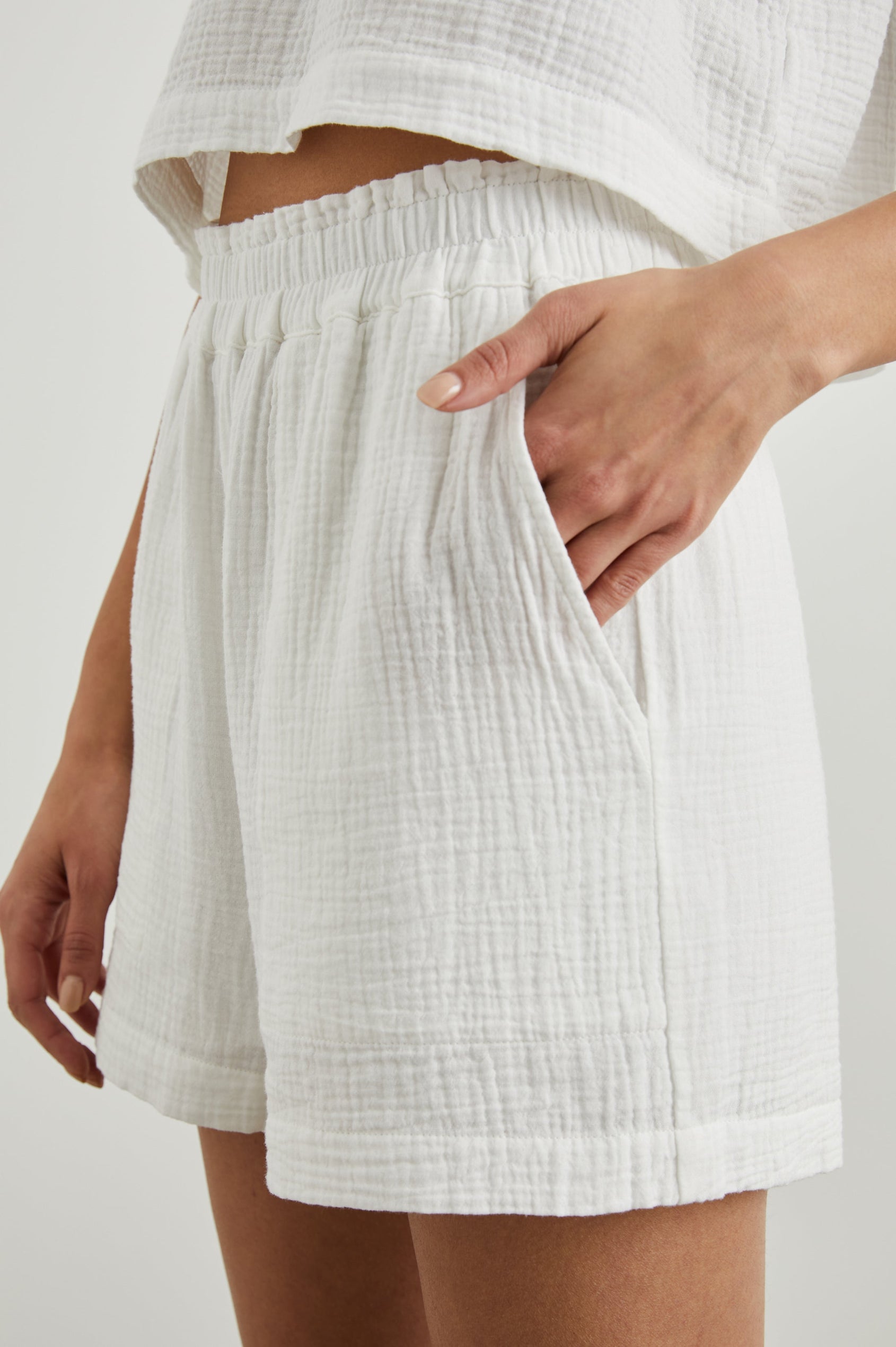 Leighton Shorts with Textured Fabric, a Smocked Elastic Waist, and Large Front Pockets in White Colorway - Front View Featured on Model