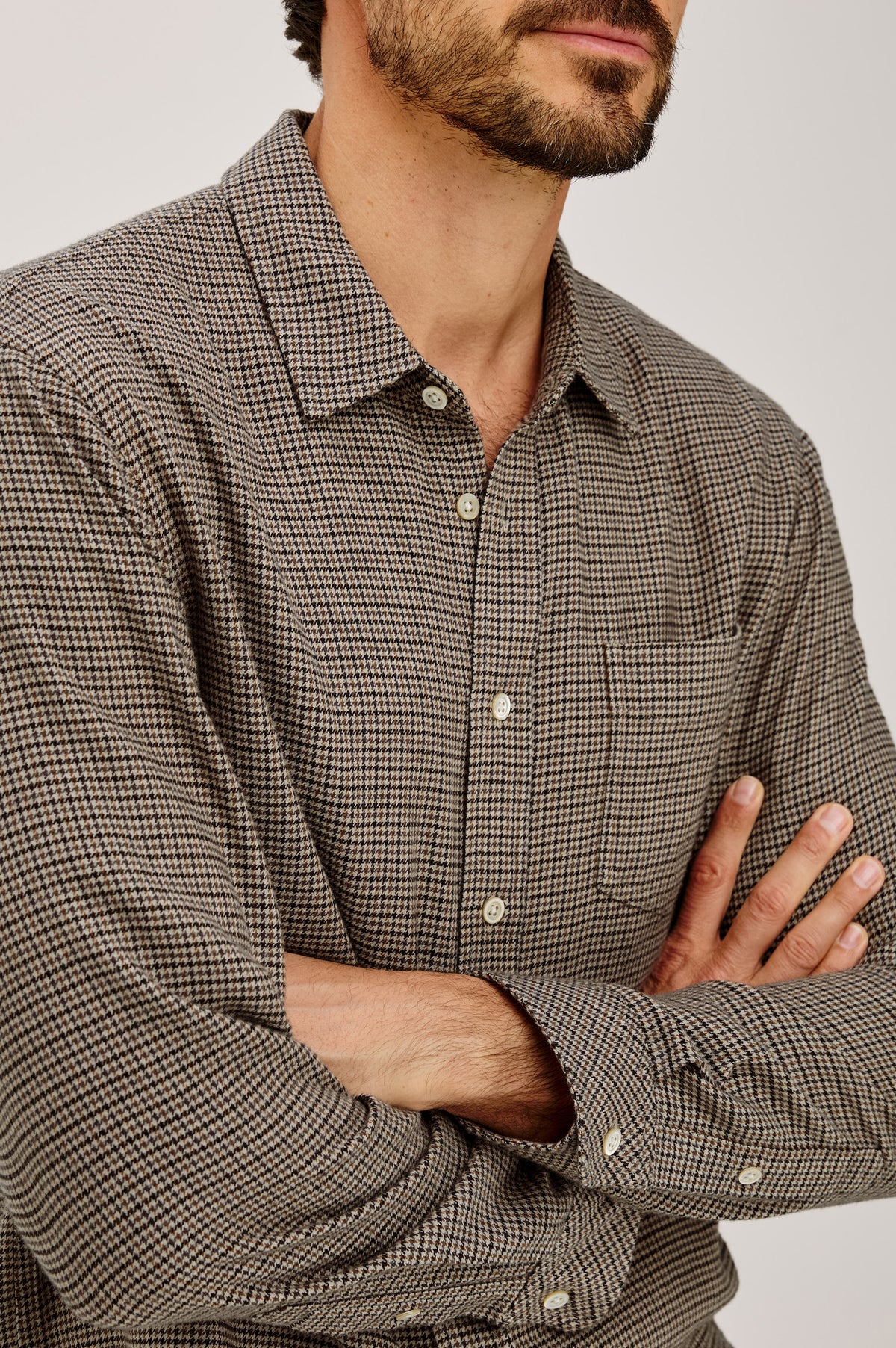Lennox Shirt in Houndstooth Cotton-Rayon Blend With Front Buttons, Single Chest Pocket, Point Collar, and Long Sleeves in Cotswold Houndstooth Colorway - Upper Body Front Detail View Featured on Model.
