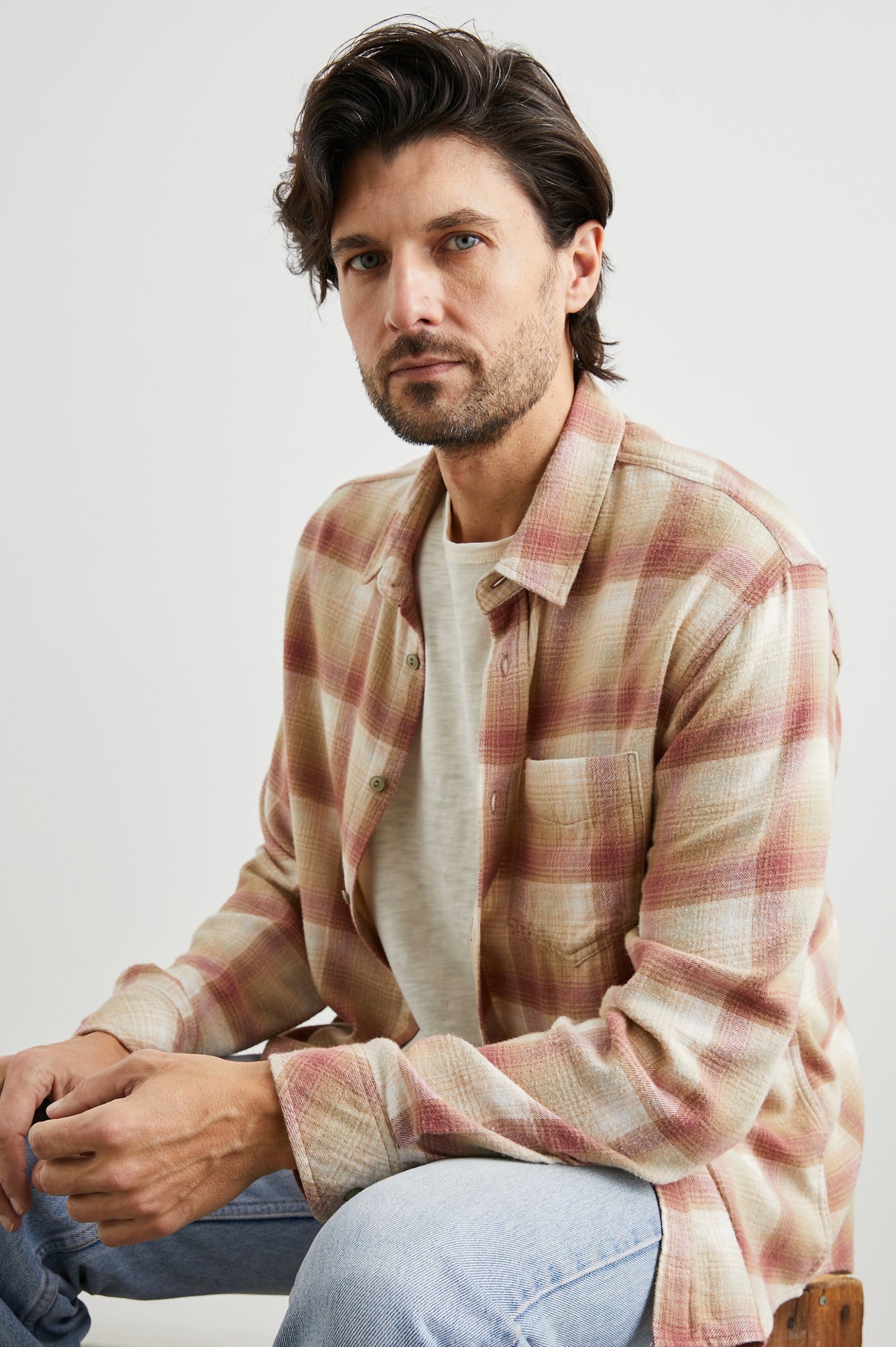 Lennox Long-Sleeve Button Up with a Chest Patch Pocket in Cranberry Finch Colorway, a plaid in Cranberry, Finch and White - Front Unbuttoned View Featured on Seated Model