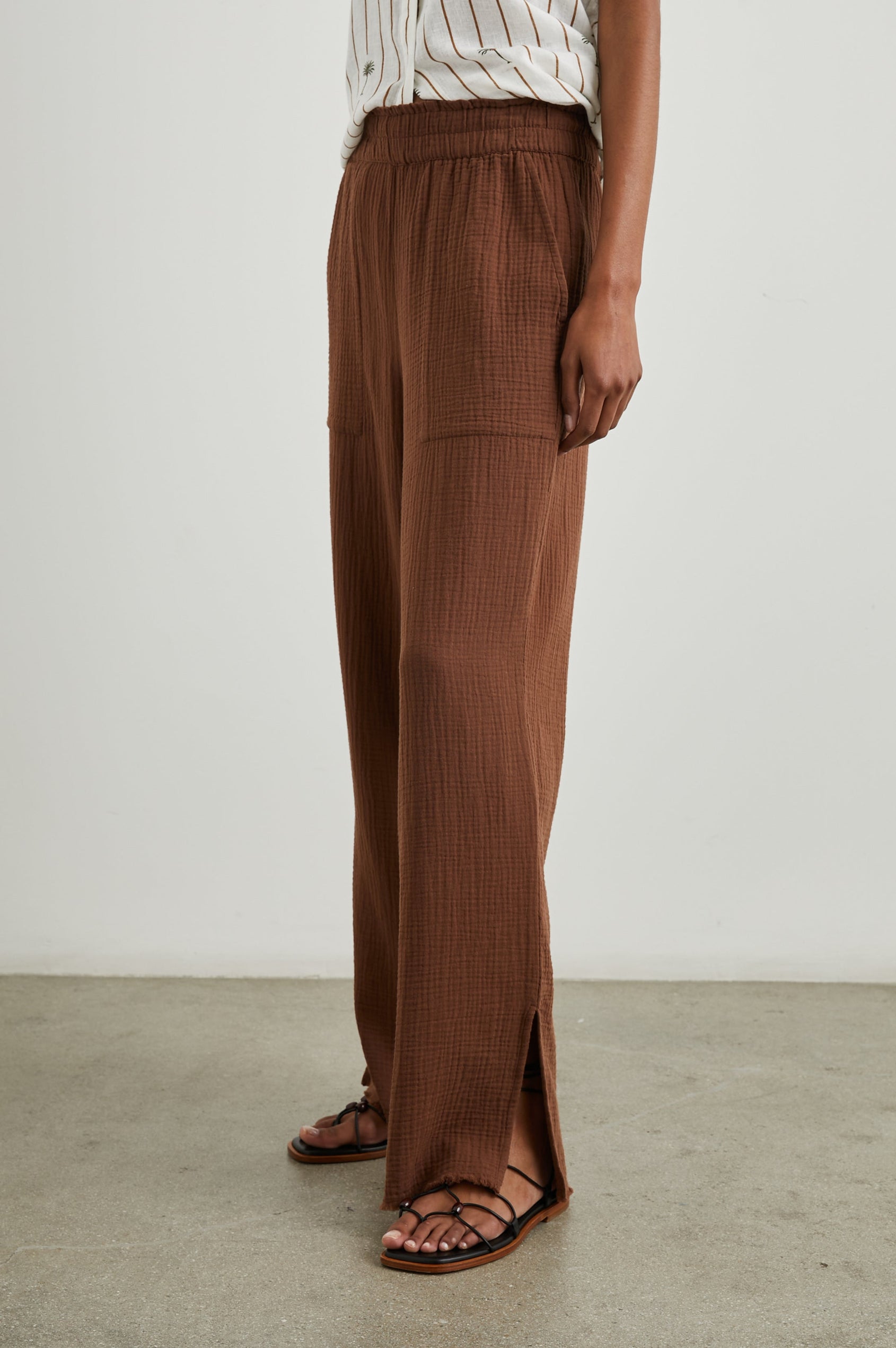 Leon Pant with a Smocked Waistband, Short Side Slits on Outer Leg and Two Front Seam Pockets in Cacao Colorway - Side View Featured on Model