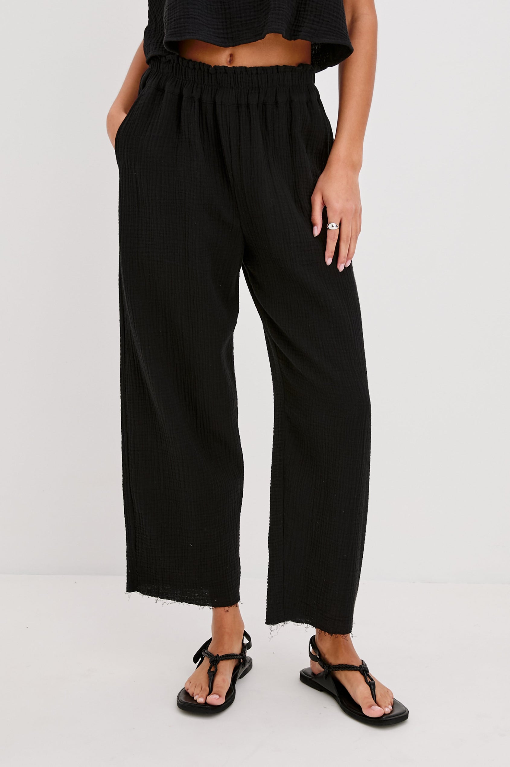 Leon Crop Cotton Gauze Pant With Hemline Slit And Elastic Waist In Colorway Black - Front View Featured On Model