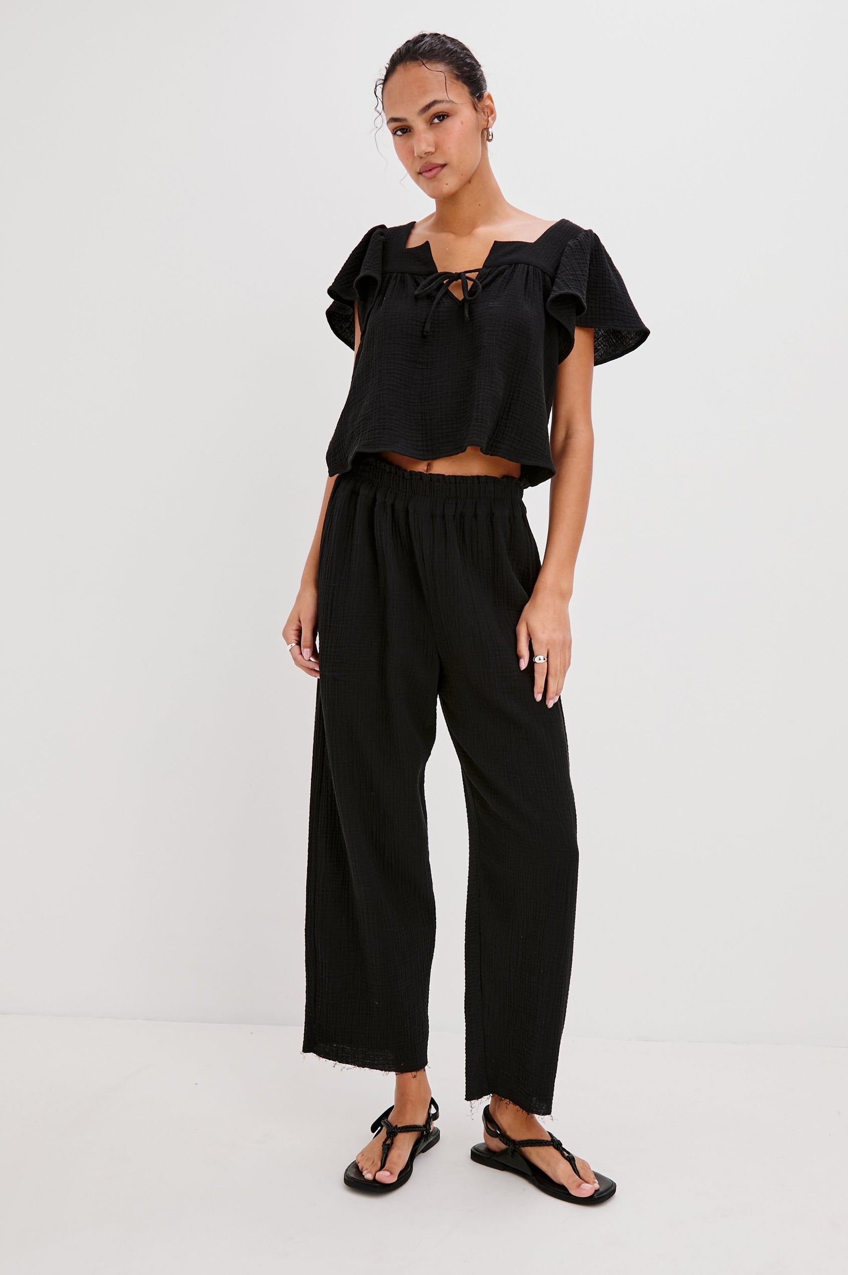 Leon Crop Cotton Gauze Pant With Hemline Slit And Elastic Waist In Colorway Black - Front View Featured On Model