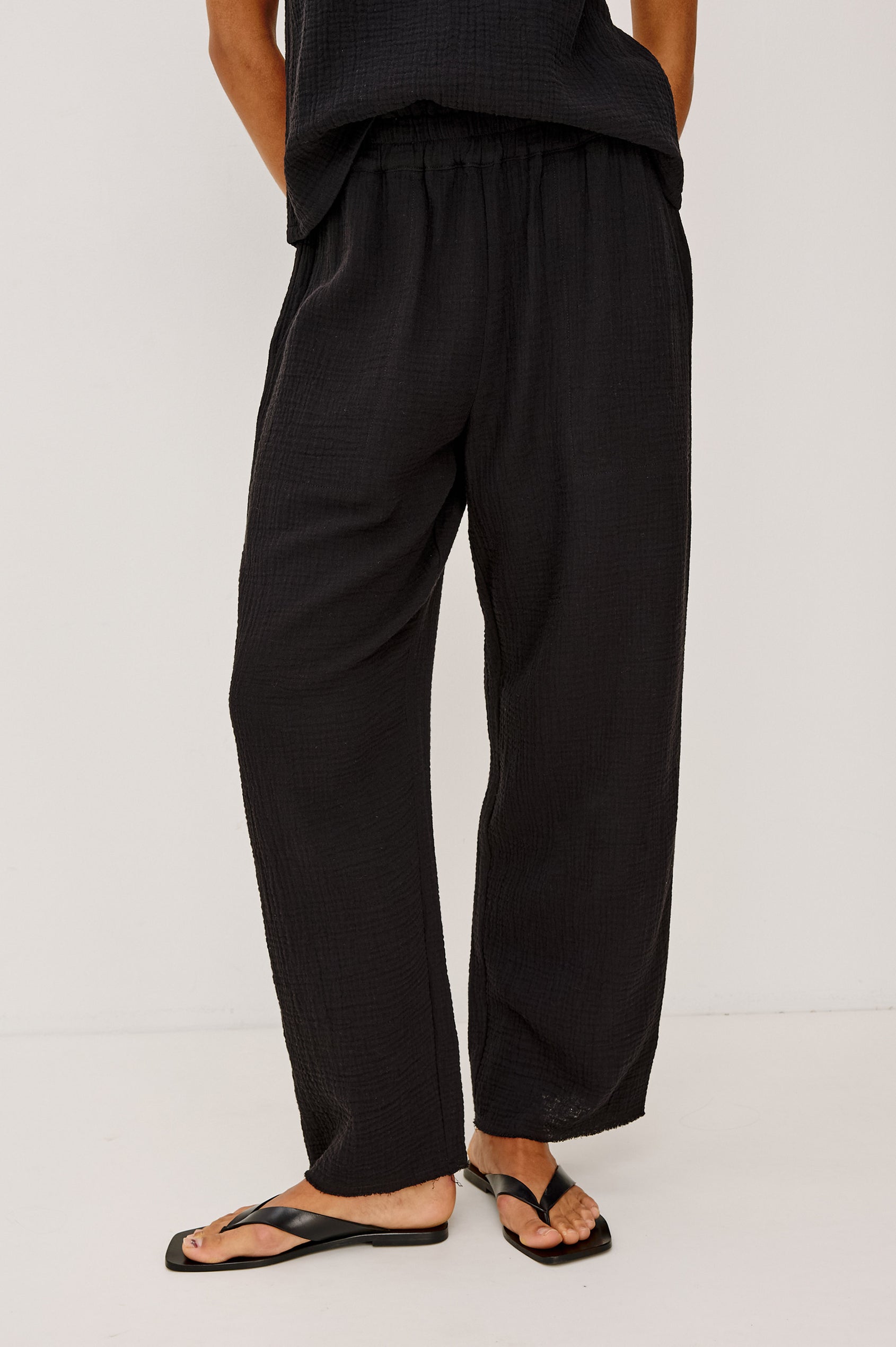 Leon Crop Cotton Gauze Pant With Hemline Slit And Elastic Waist In Colorway Black - Front View Featured On Model