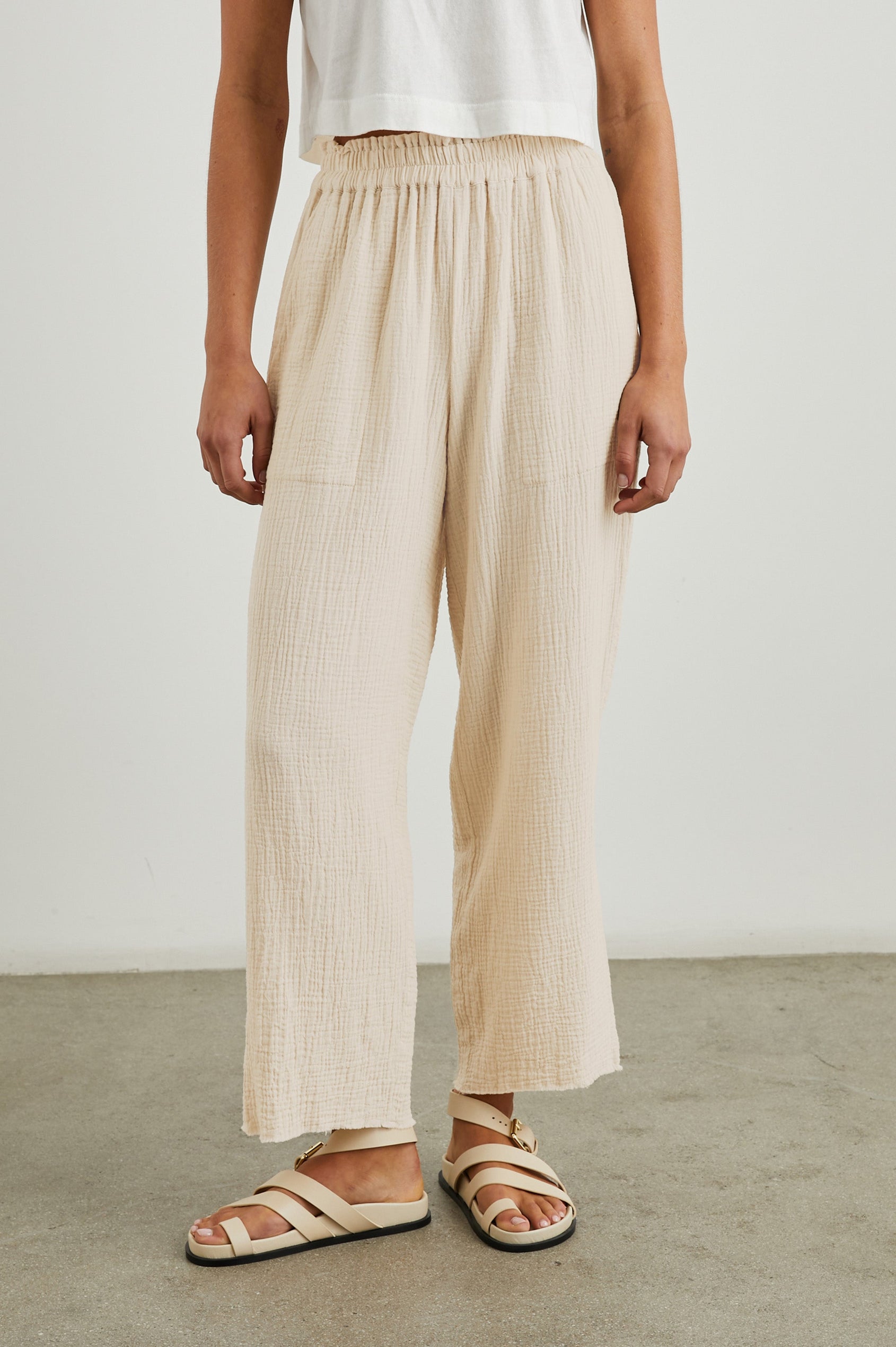 Leon Crop Pant with a Smocked Waistband and Two Front Seam Pockets in Flax Colorway - Front View Featured on Model