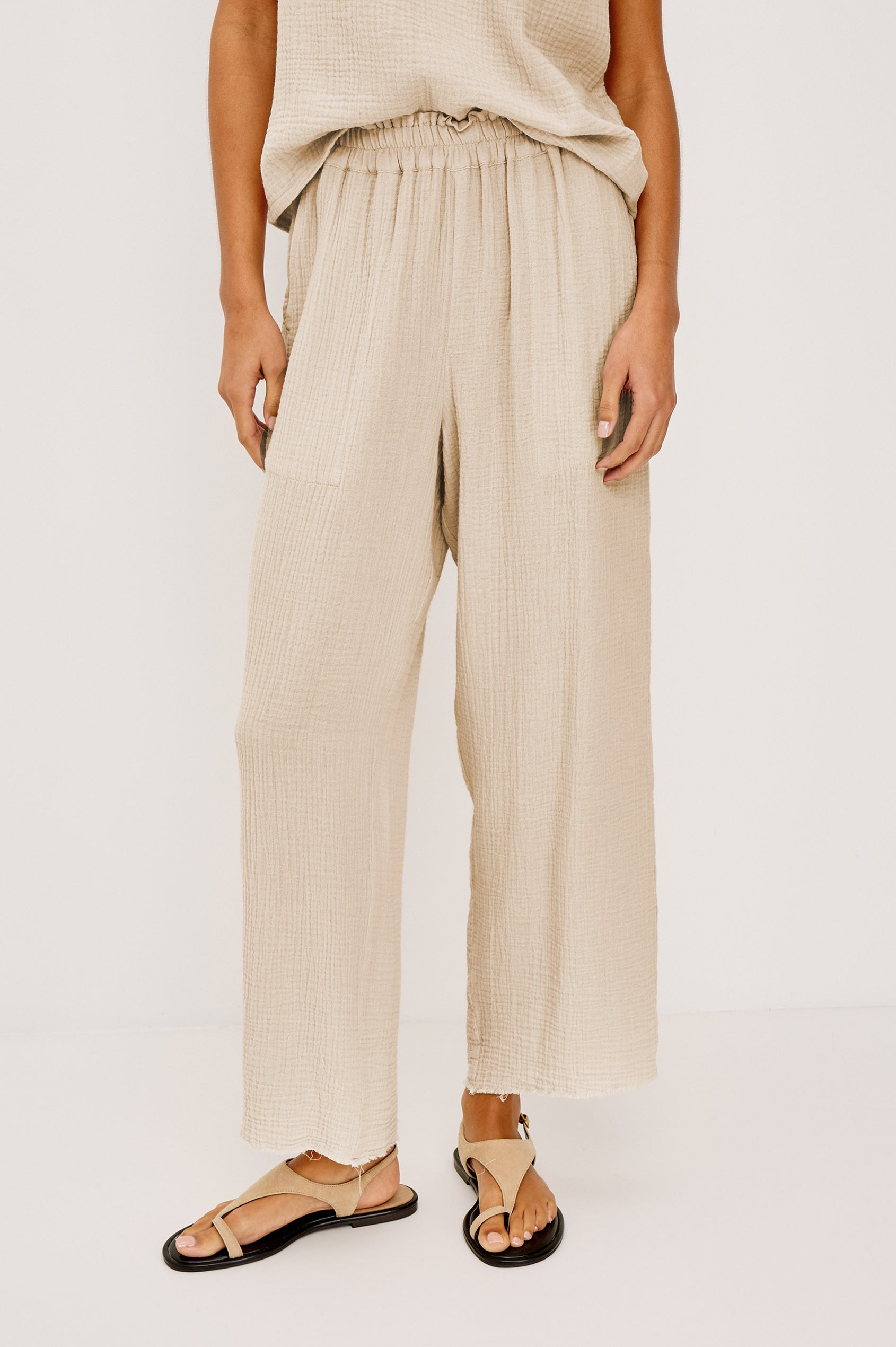 Leon Crop Pant with a Smocked Waistband and Two Front Seam Pockets in Light Brown Heather Flax Colorway - Lower Body Front View Featured on Model