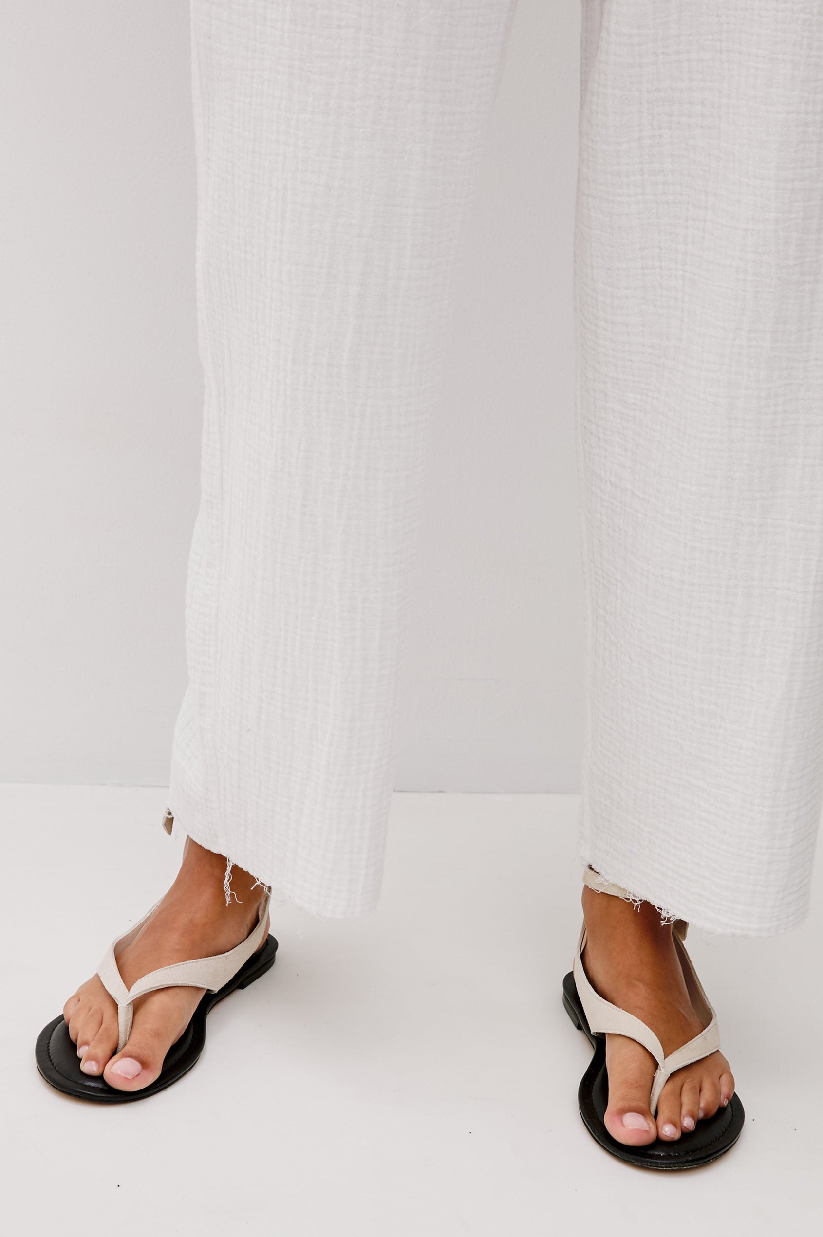 Leon Crop Cotton Gauze Pant With Hemline Slit And Elastic Waist In Colorway White - Front Detail View Featured On Model