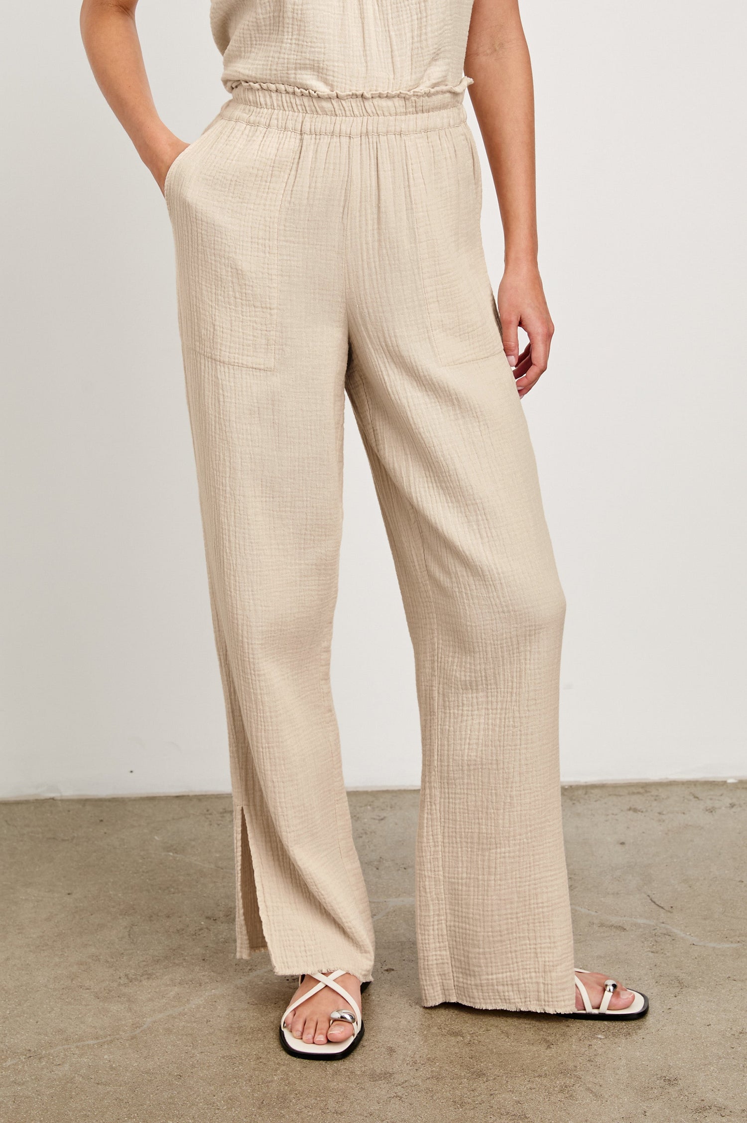 Leon Cotton Gauze Pant With Hemline Slit And Elastic Waist In Colorway Flax - Front View Featured On Model 