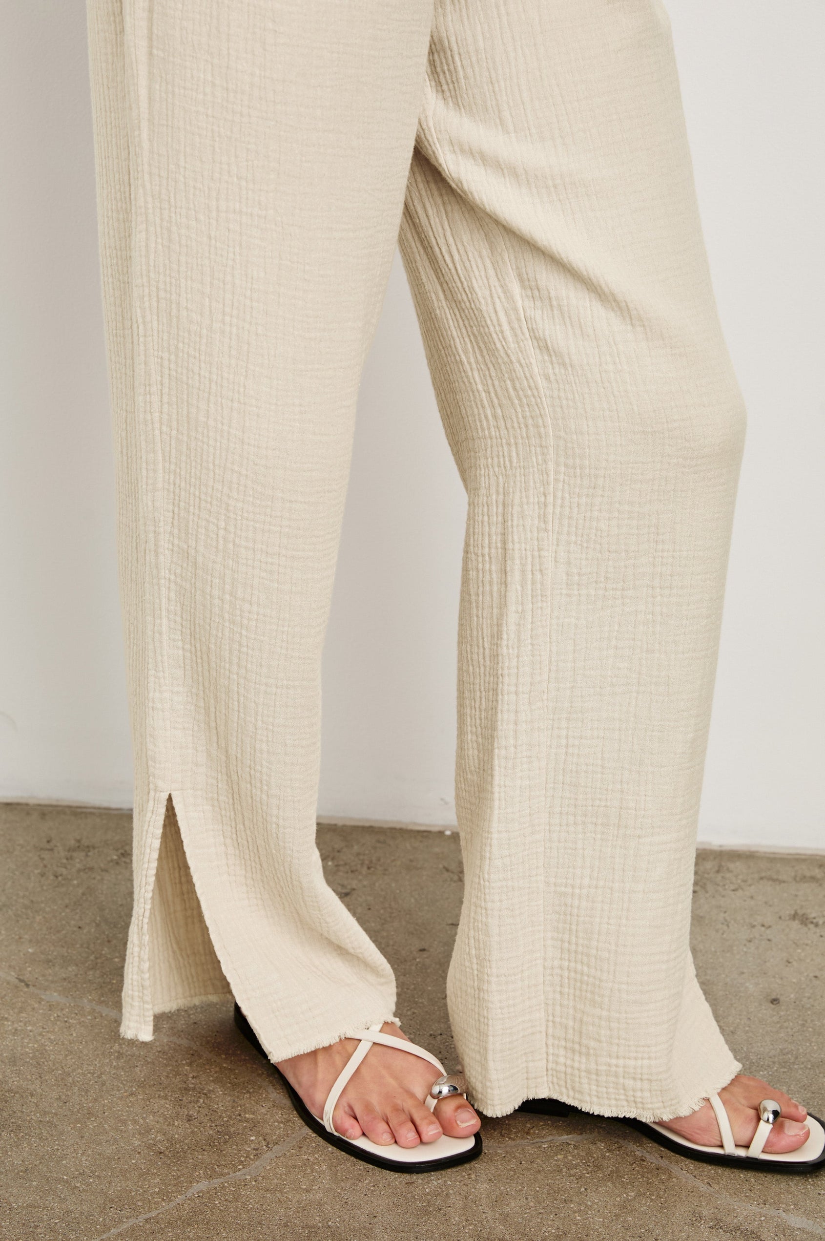 Leon Cotton Gauze Pant With Hemline Slit And Elastic Waist In Colorway Flax - Hem Detail Featured On Model