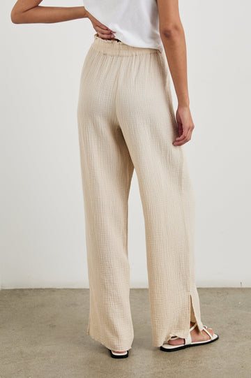 Leon Cotton Gauze Pant With Hemline Slit And Elastic Waist In Colorway Flax -  Back View Featured On Model