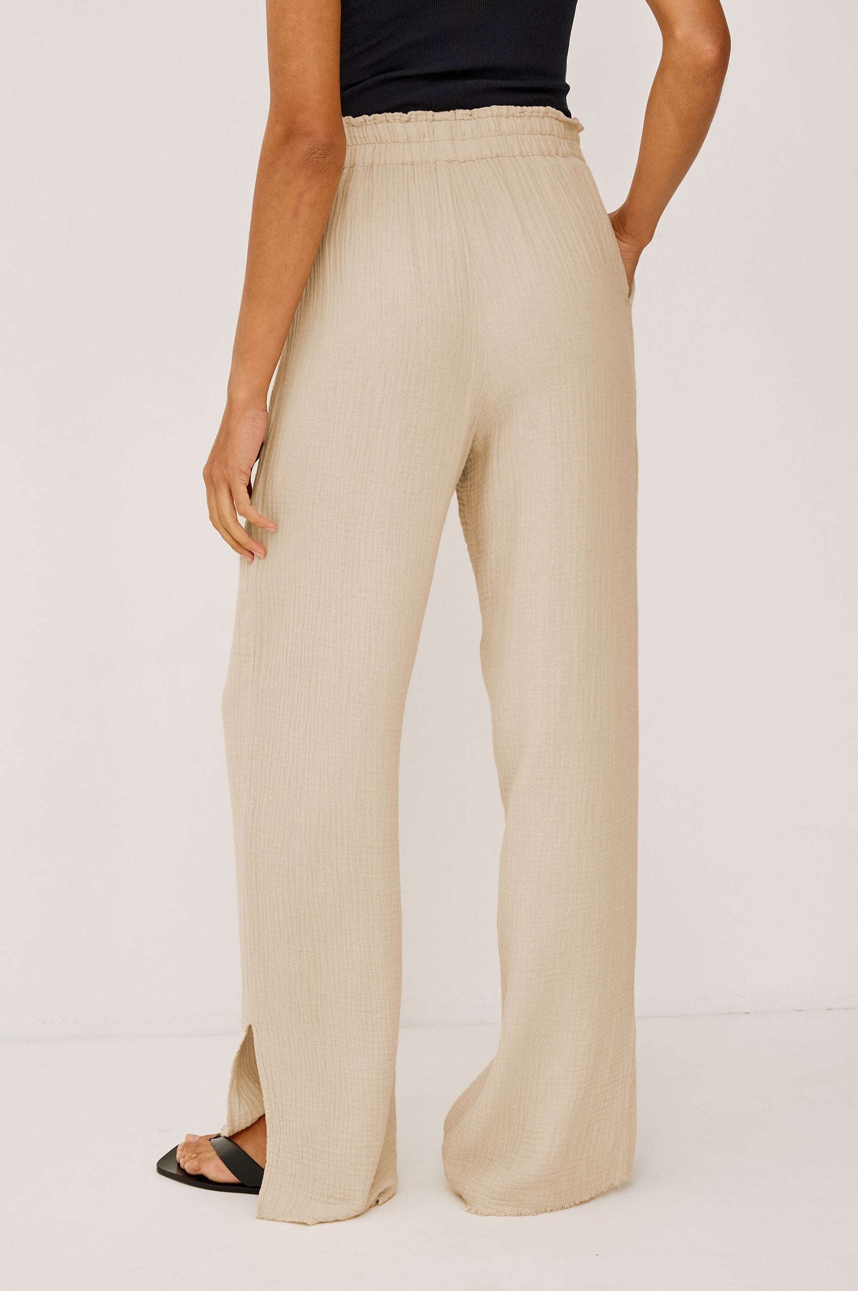 Leon Cotton Gauze Pant With Hemline Slit And Elastic Waist In Colorway Flax - Back View Featured On Model