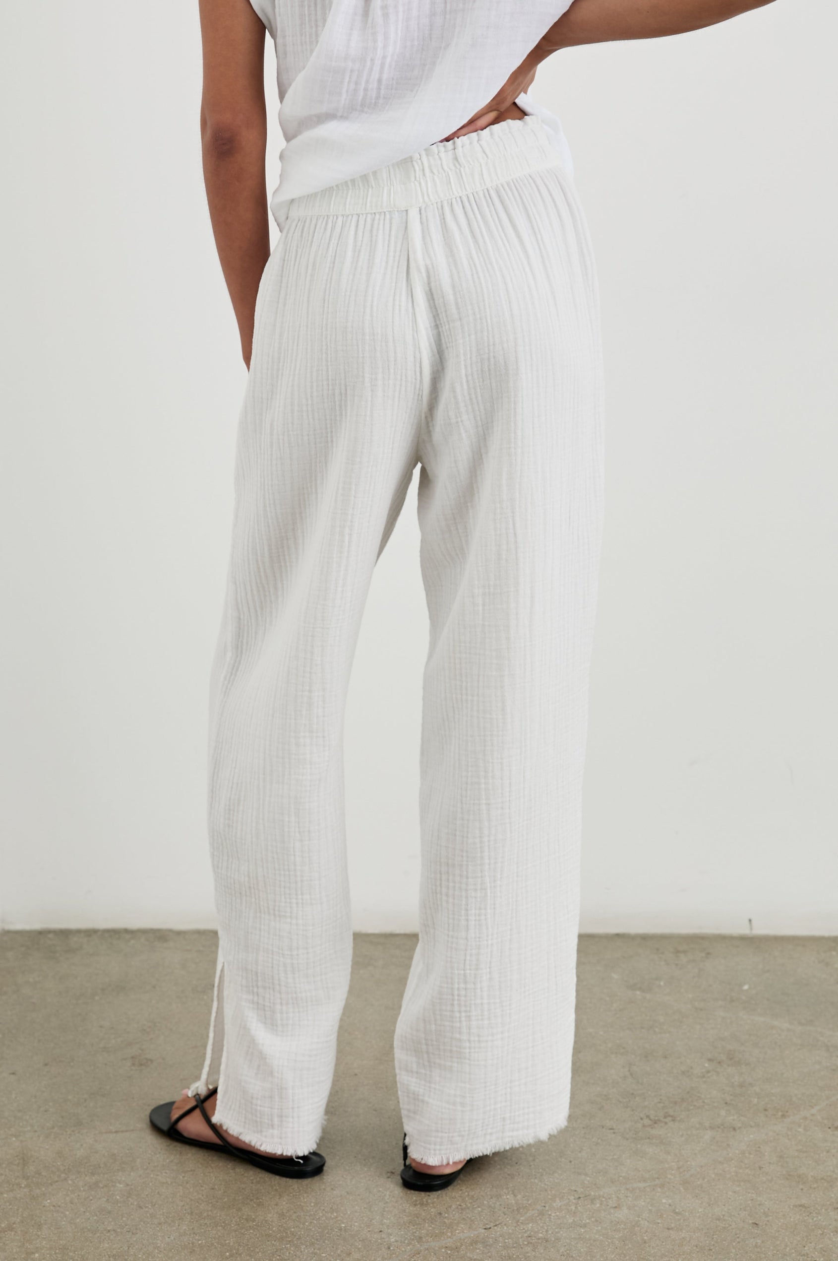 Leon Cotton Gauze Pant With Hemline Slit And Elastic Waist In Colorway White - back view on model