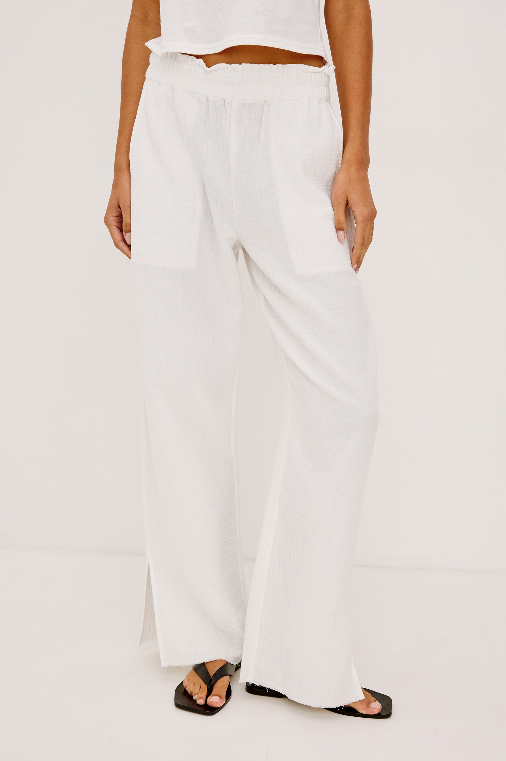 Leon Crop Pant in Double Gauze Cotton With Wide Straight Legs, Side Slits, and Smocked Waistband in White Colorway - Lower Body Front View Featured on Model