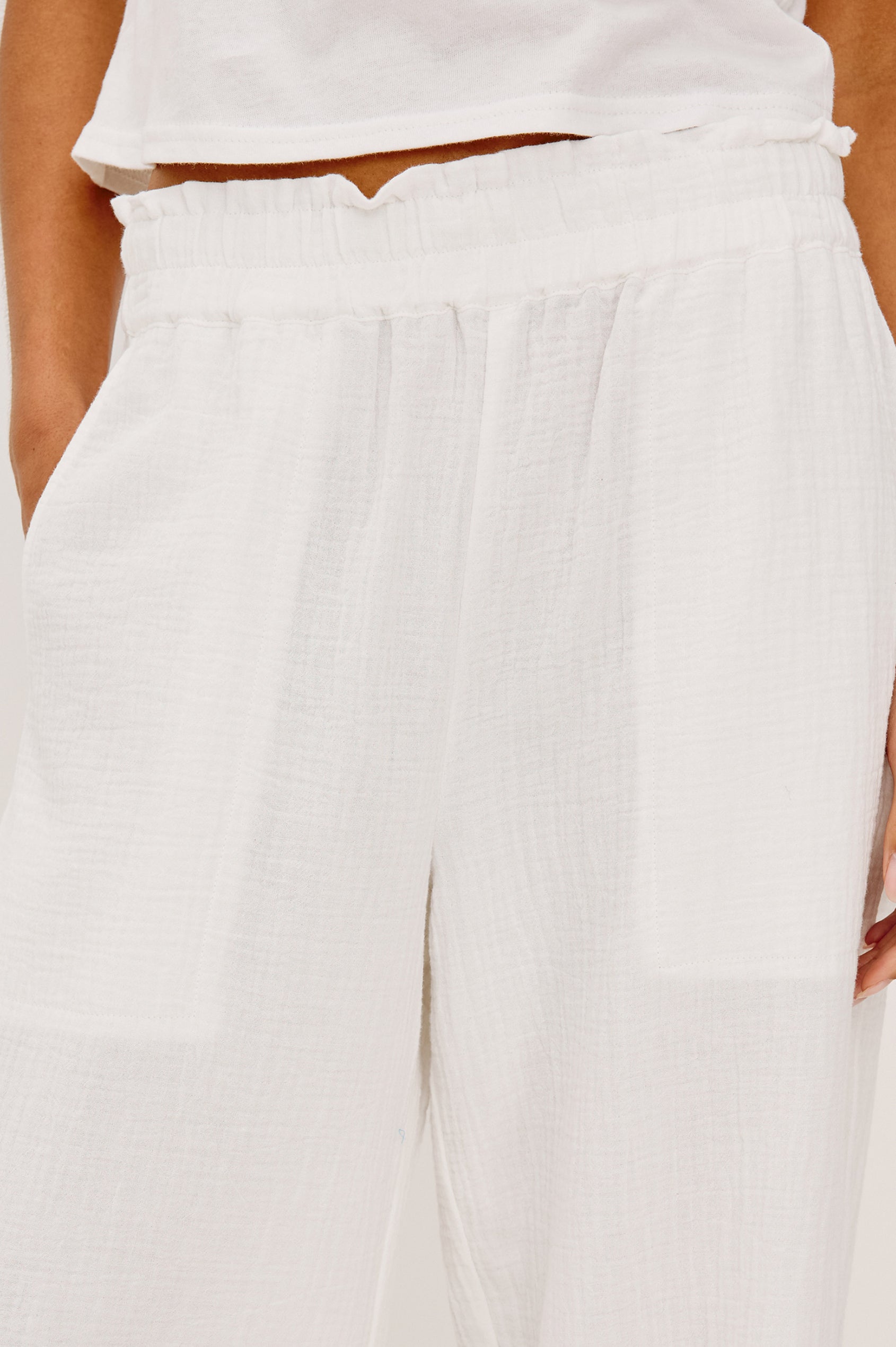 Leon Crop Pant in Double Gauze Cotton With Wide Straight Legs, Side Slits, and Smocked Waistband in White Colorway - Lower Body Front Close Up View Featured on Model