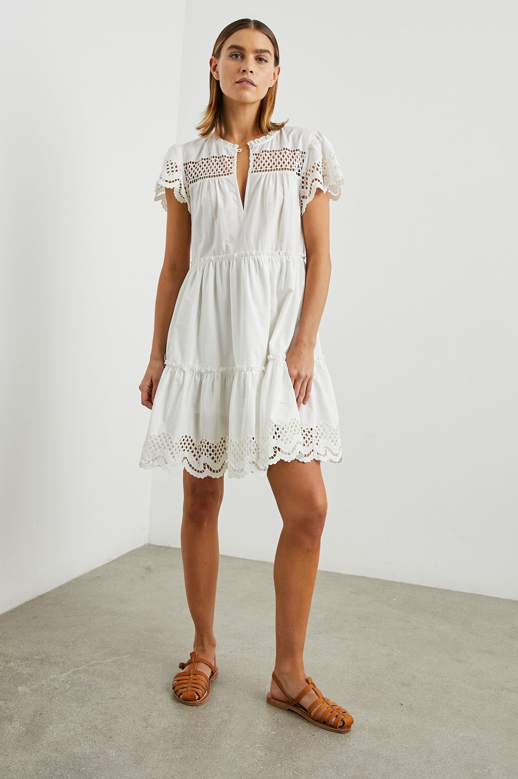 Lettie Short Sleeve Mini Dress with a Button Keyhole Neckline, a Tiered Skirt, and an Eyelet Design on the Yoke, Sleeves and Hem in White Colorway - Front Full Body View Featured on Model 