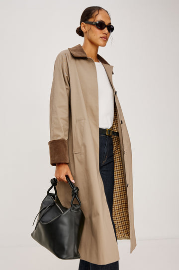 Full-length coat with a classic silhouette in Raisin Colorway. The coat is fully lined in plaid and finished with corduroy accents at the cuffs and collar for a heritage-inspired look. Front View featured on Model.