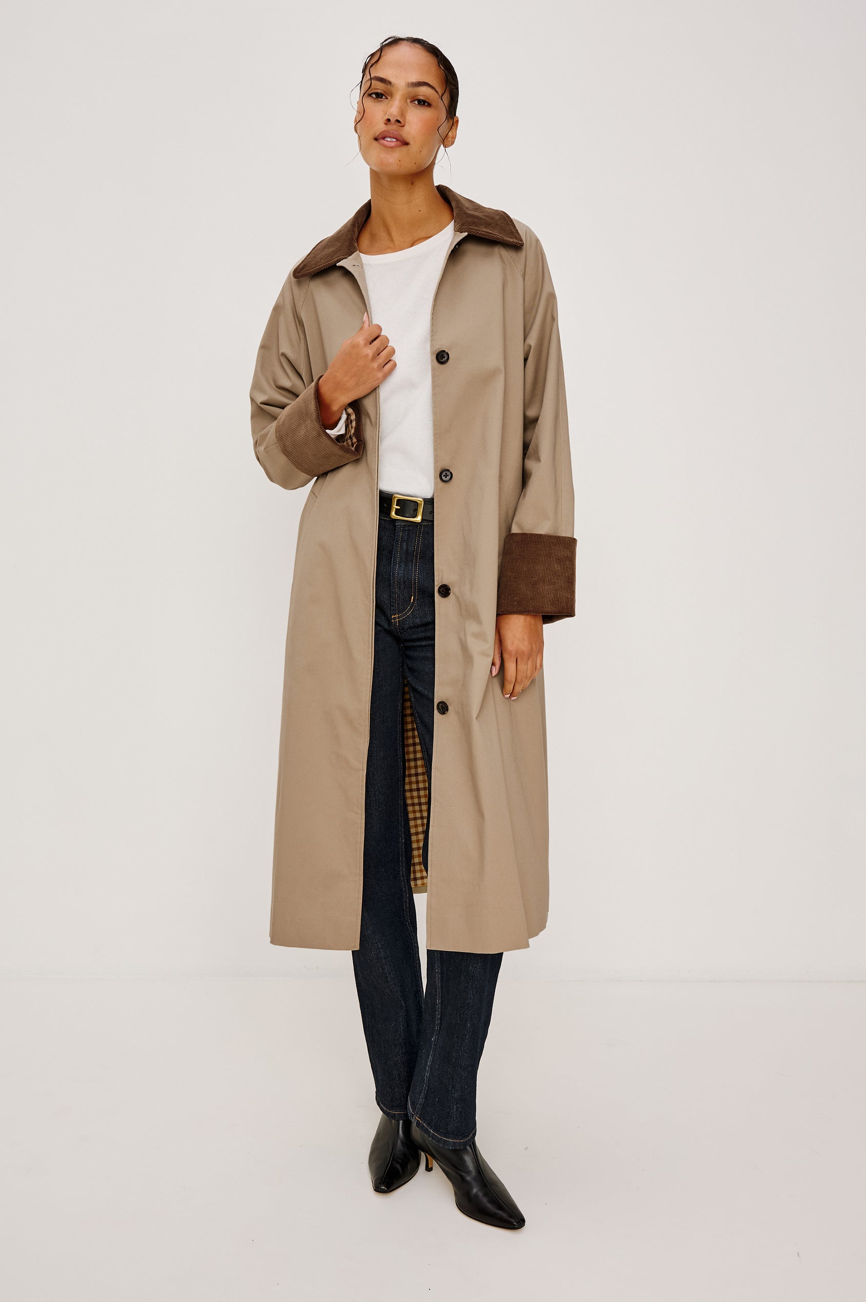 Full-length coat with a classic silhouette in Raisin Colorway. The coat is fully lined in plaid and finished with corduroy accents at the cuffs and collar for a heritage-inspired look. Front View featured on Model.