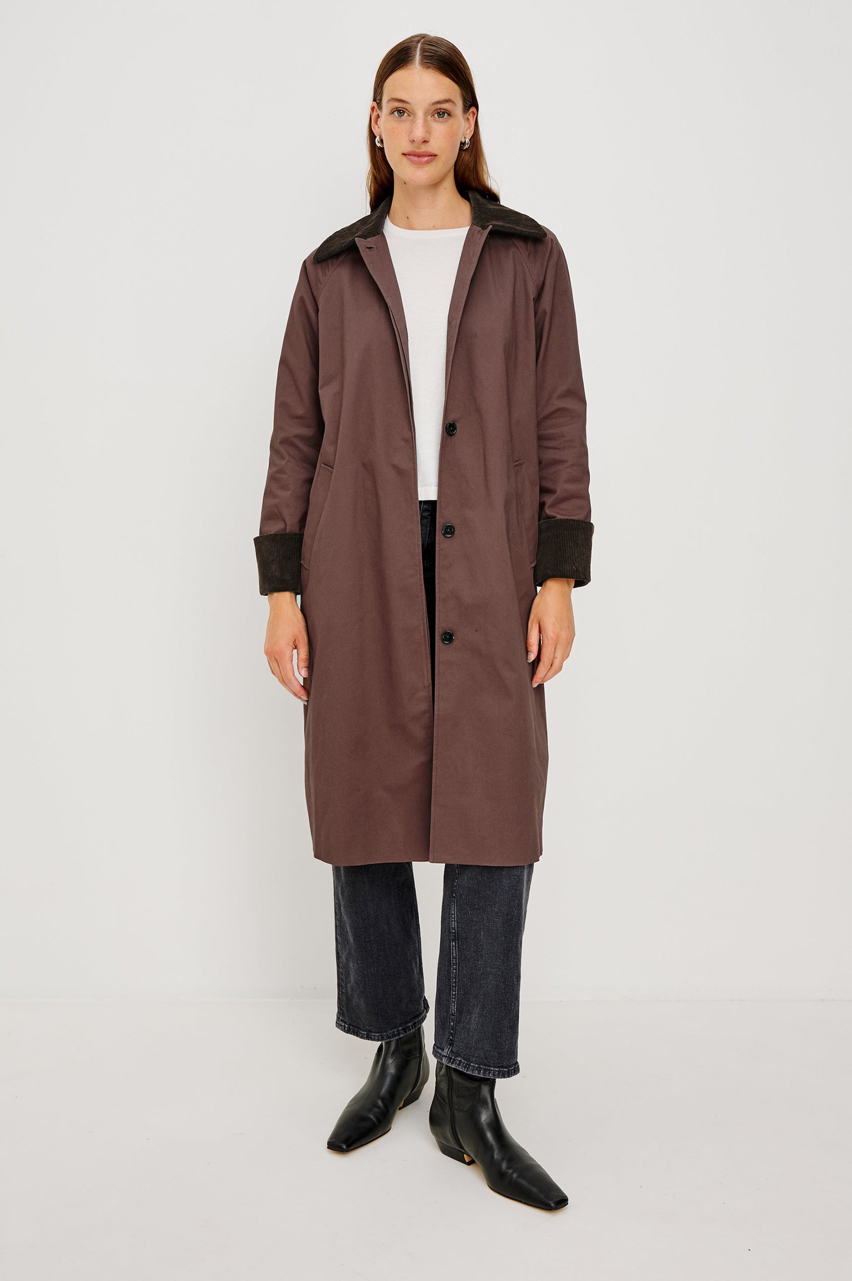 Full-length coat with a classic silhouette in Raisin Colorway. The coat is fully lined in plaid and finished with corduroy accents at the cuffs and collar for a heritage-inspired look. Front View featured on Model.