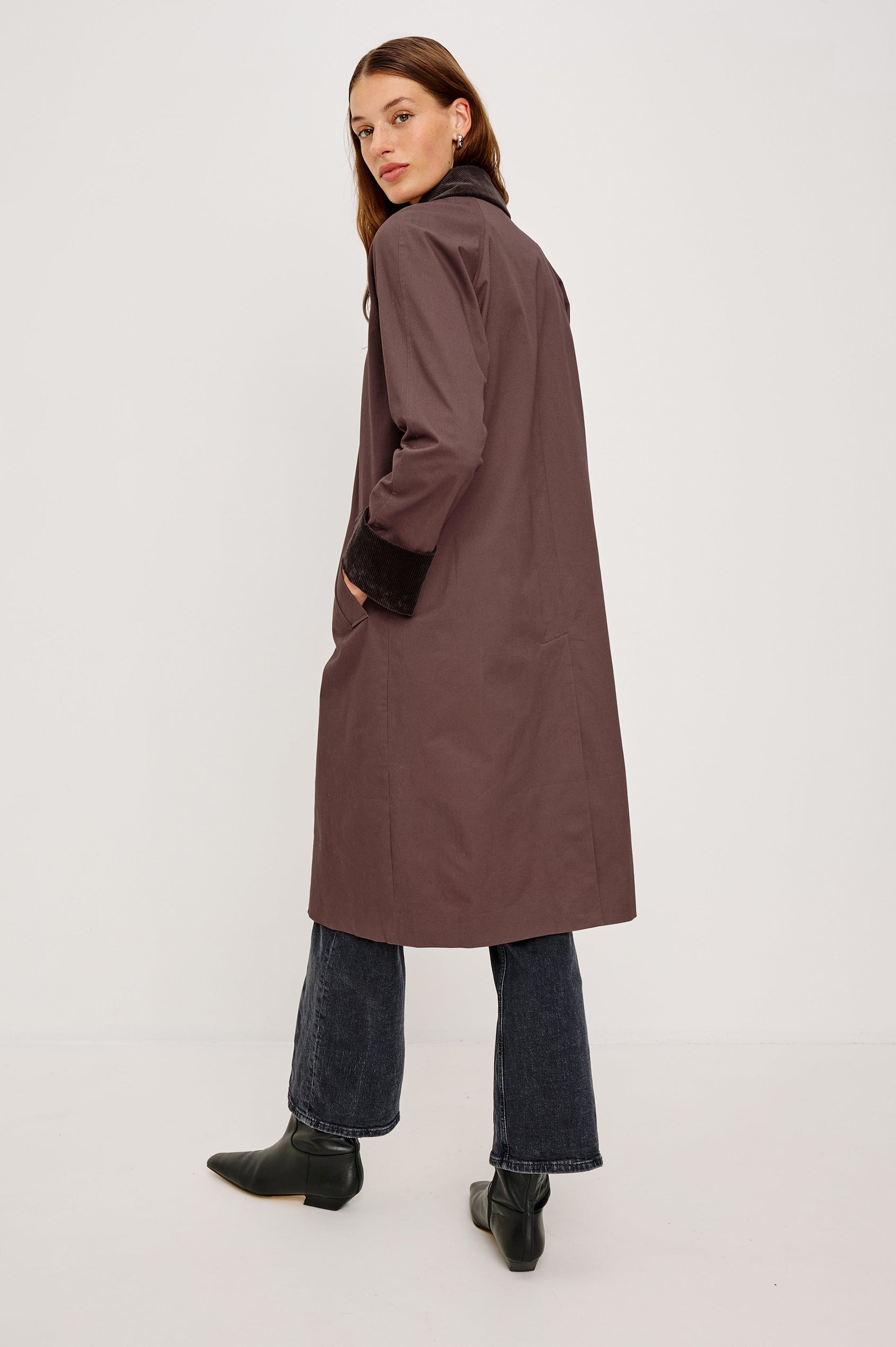 Full-length coat with a classic silhouette in Raisin Colorway. The coat is fully lined in plaid and finished with corduroy accents at the cuffs and collar for a heritage-inspired look. Back View featured on Model.
