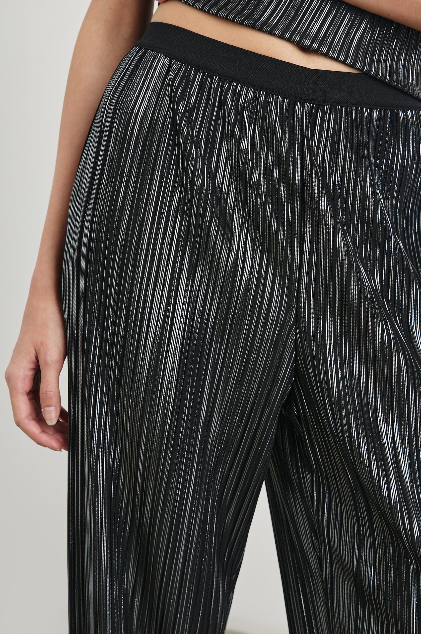 Liana Micro-Pleated Pants with an Elastic Waist in Gunmetal Colorway, Thin black, white and grey Vertical Stripes - Front View Featured on Model 