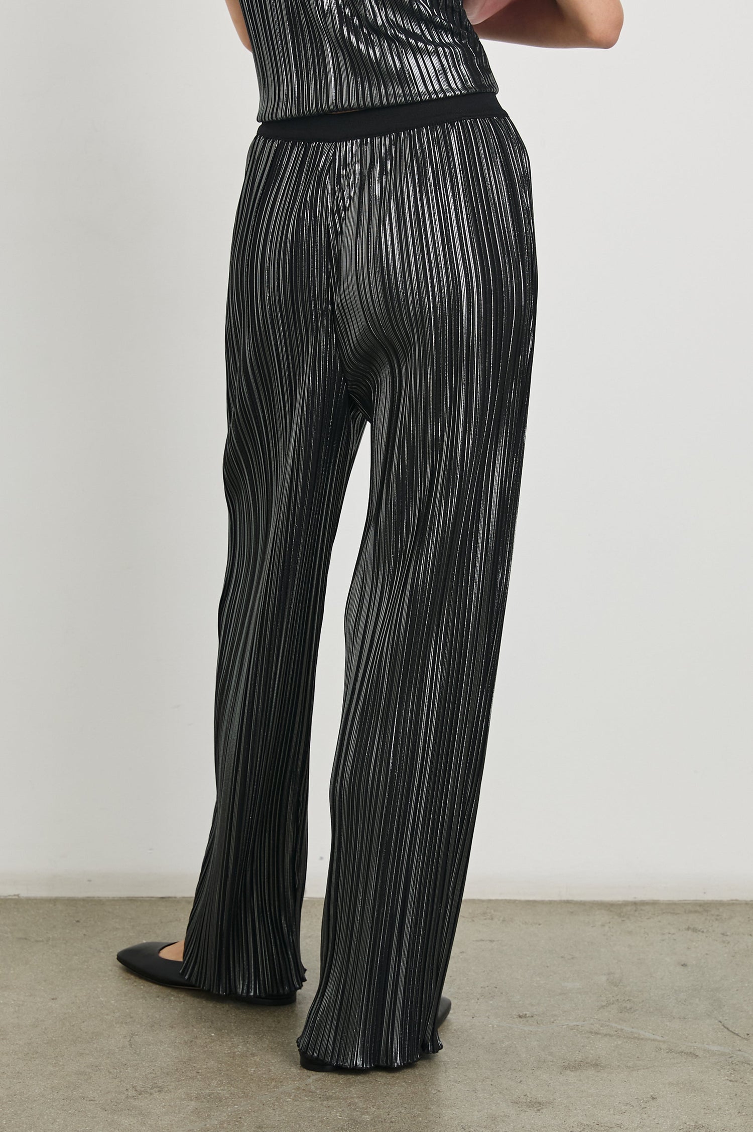 Liana Micro-Pleated Pants with an Elastic Waist in Gunmetal Colorway, Thin black, white and grey Vertical Stripes - Back View Featured on Model 