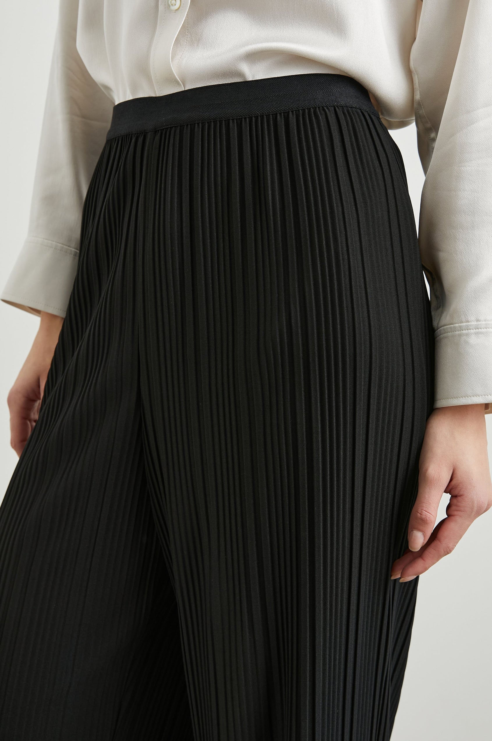 Liana Micro-Pleated Pants with an Elastic Waist in Jet Colorway - Front View Featured on Model 