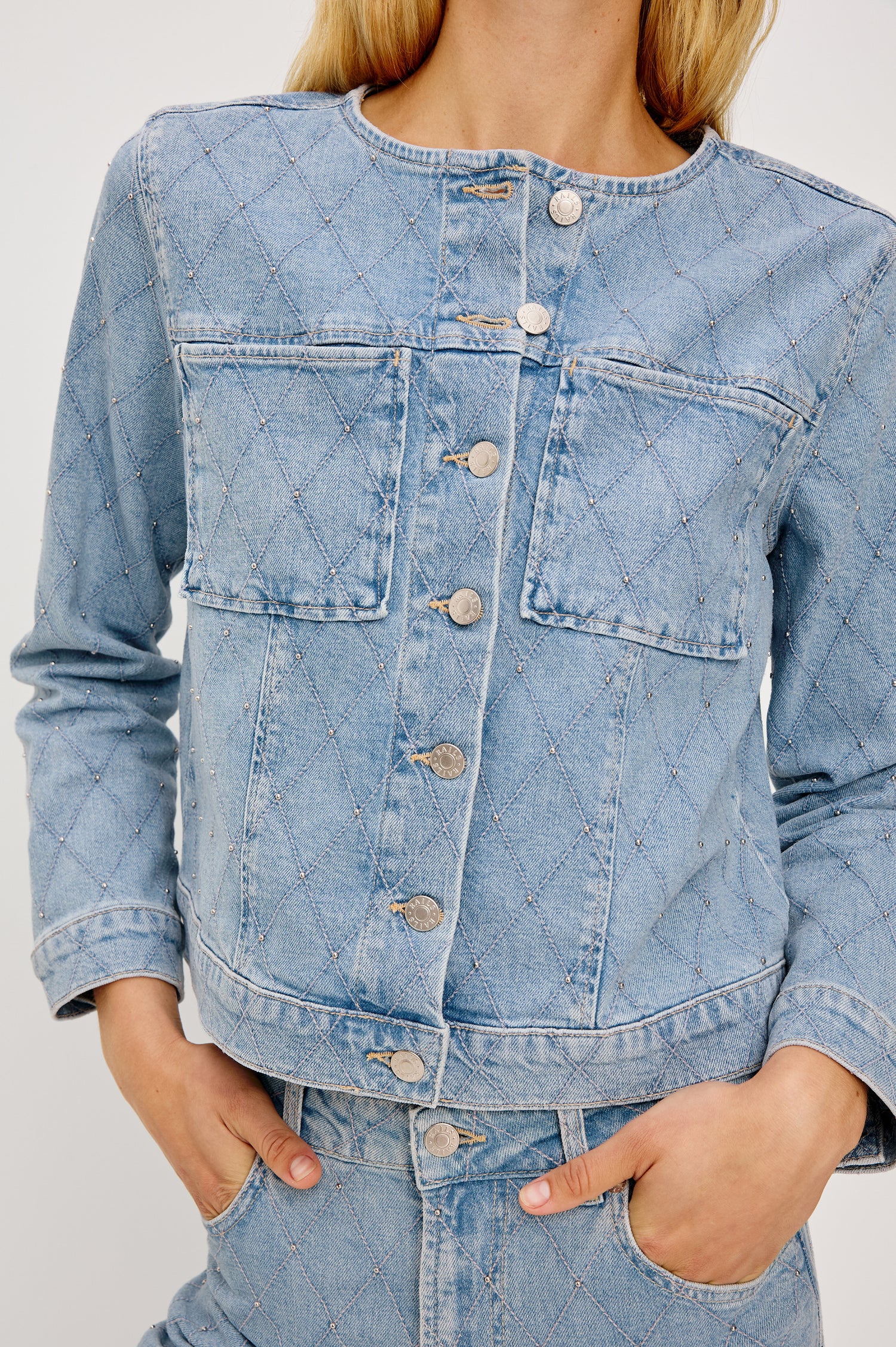 Lido Lady Jacket in Light Stretch Denim With Cropped Boxy Fit, Collarless Neckline, Front Buttons, Long Sleeves, and Chest Patch Pockets in Quilted Stud Colorway - Upper Body Front View Featured on Model
