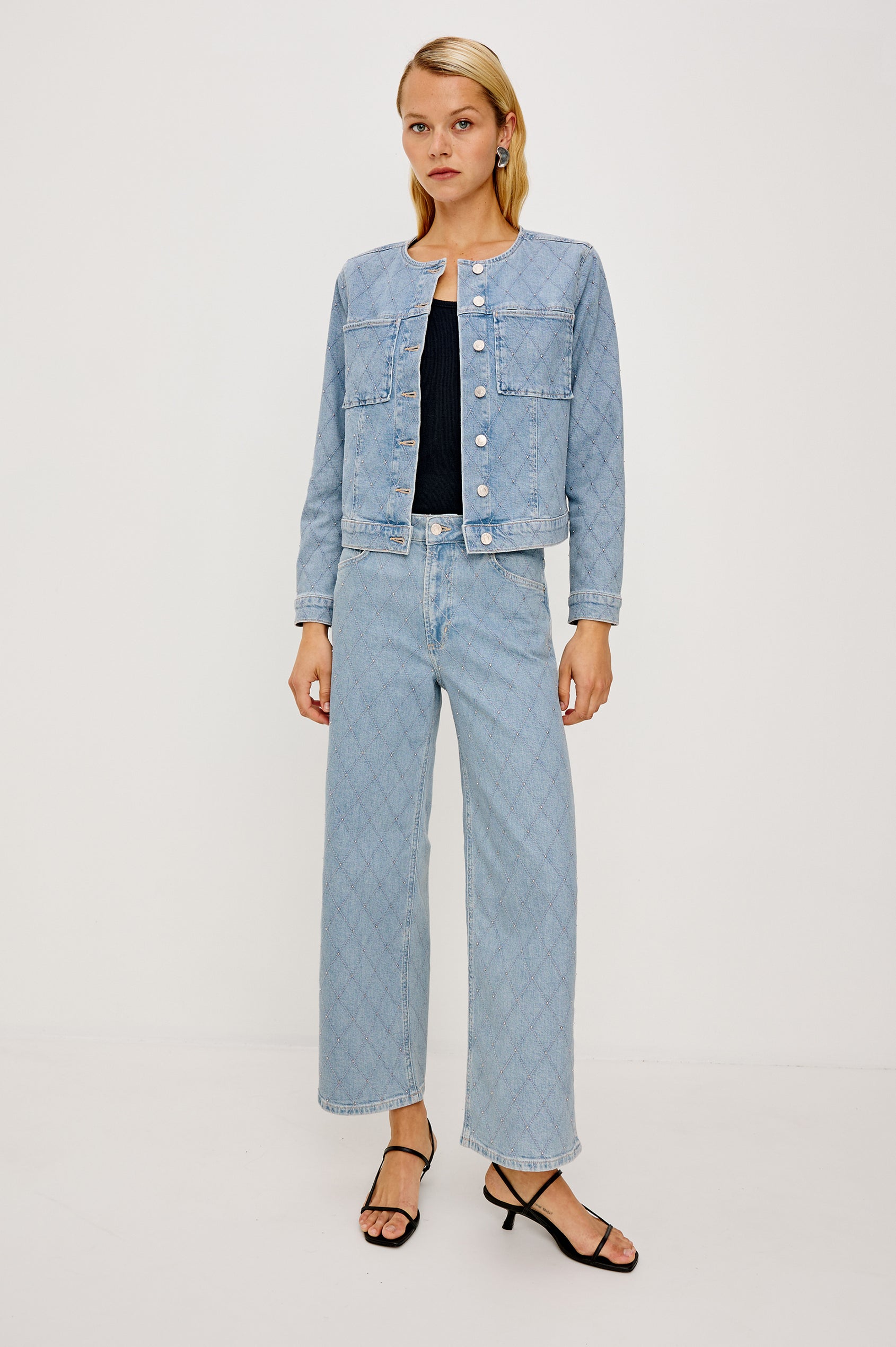 Lido Lady Jacket in Light Stretch Denim With Cropped Boxy Fit, Collarless Neckline, Front Buttons, Long Sleeves, and Chest Patch Pockets in Quilted Stud Colorway - Full Body Front View Featured on Model