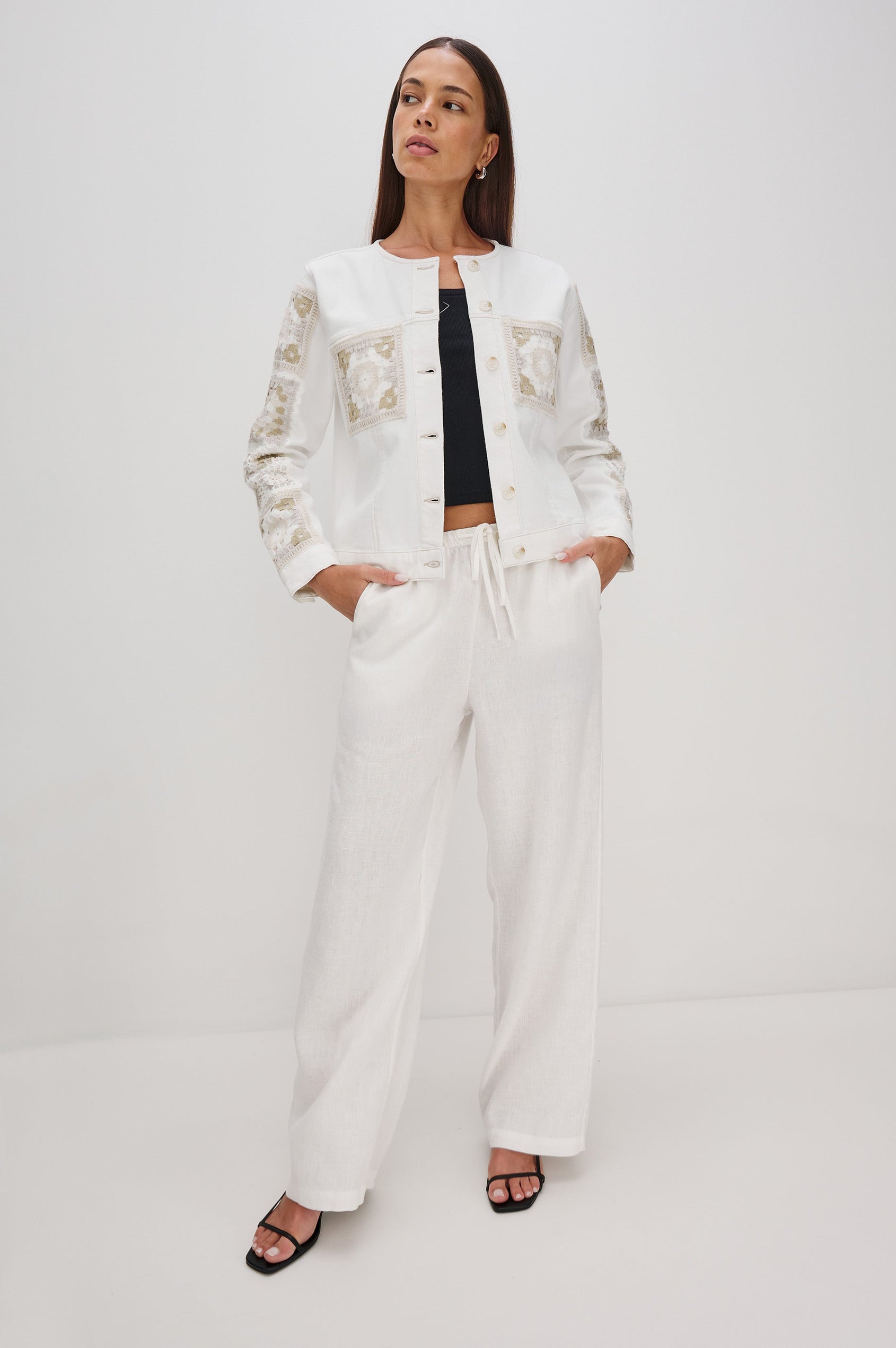 Lido collarless denim jacket with contrast embroidery details, chest pockets and embellishment buttons in vintage ecru crochet colorway. Full Body front view on model.