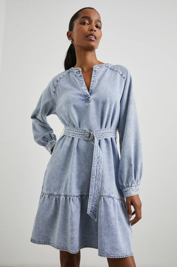Lila Long-Sleeve Denim Mini Dress with a Fabric Double Ring Belt, a V Neck and Snap Cuffs in Faded Indigo Colorway - Front View Featured on Model 