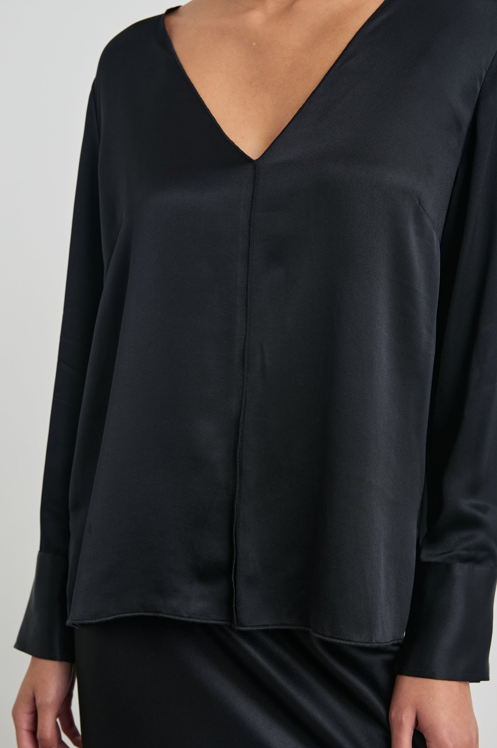 Liliana Long-Sleeve Top with a V Neck, Button Cuffs and a Vertical Seam Down the Front and Back in Black Colorway - Front View Featured on Model
