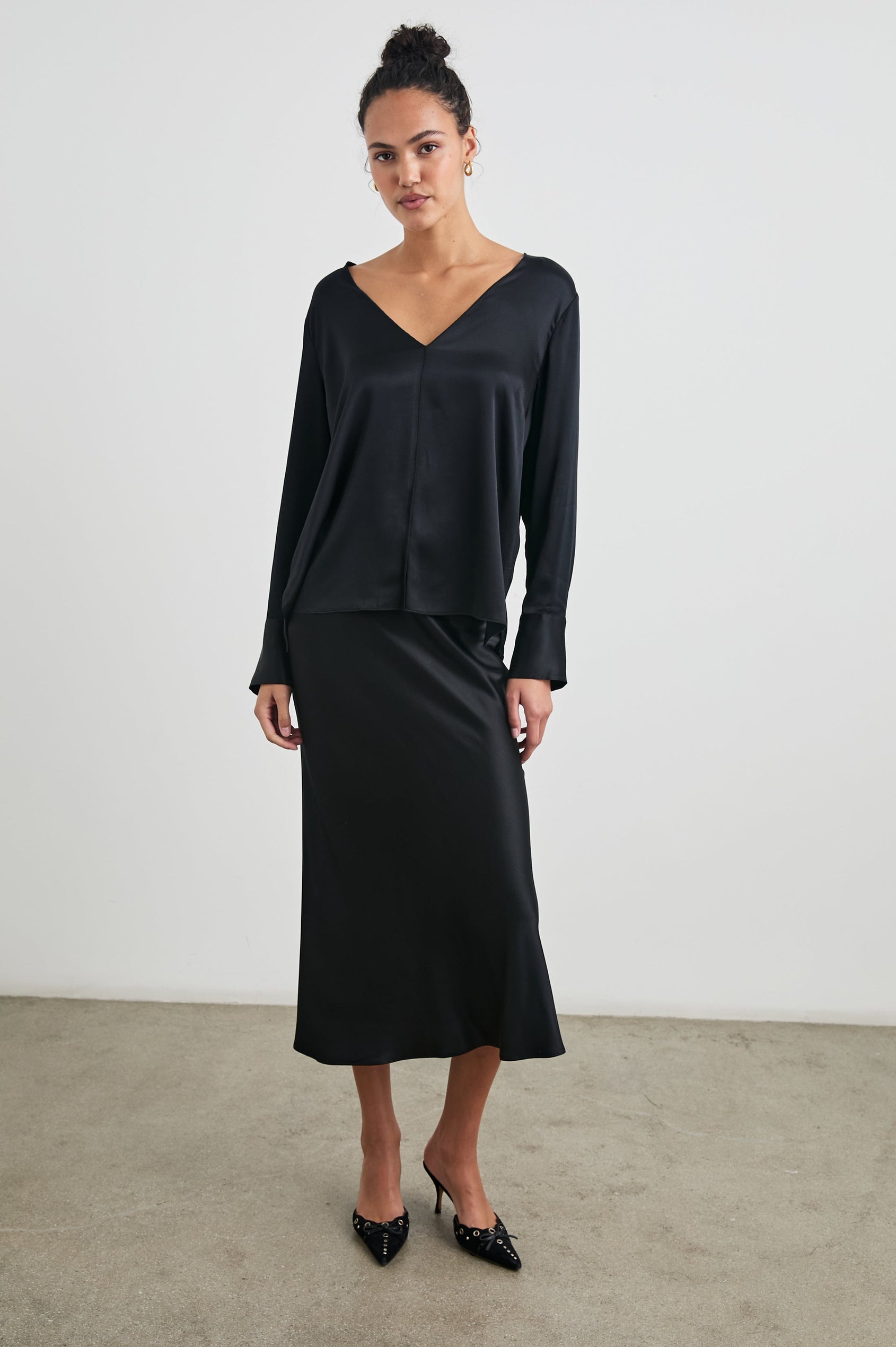 Liliana Long-Sleeve Top with a V Neck, Button Cuffs and a Vertical Seam Down the Front and Back in Black Colorway - Front Full Body View Featured on Model