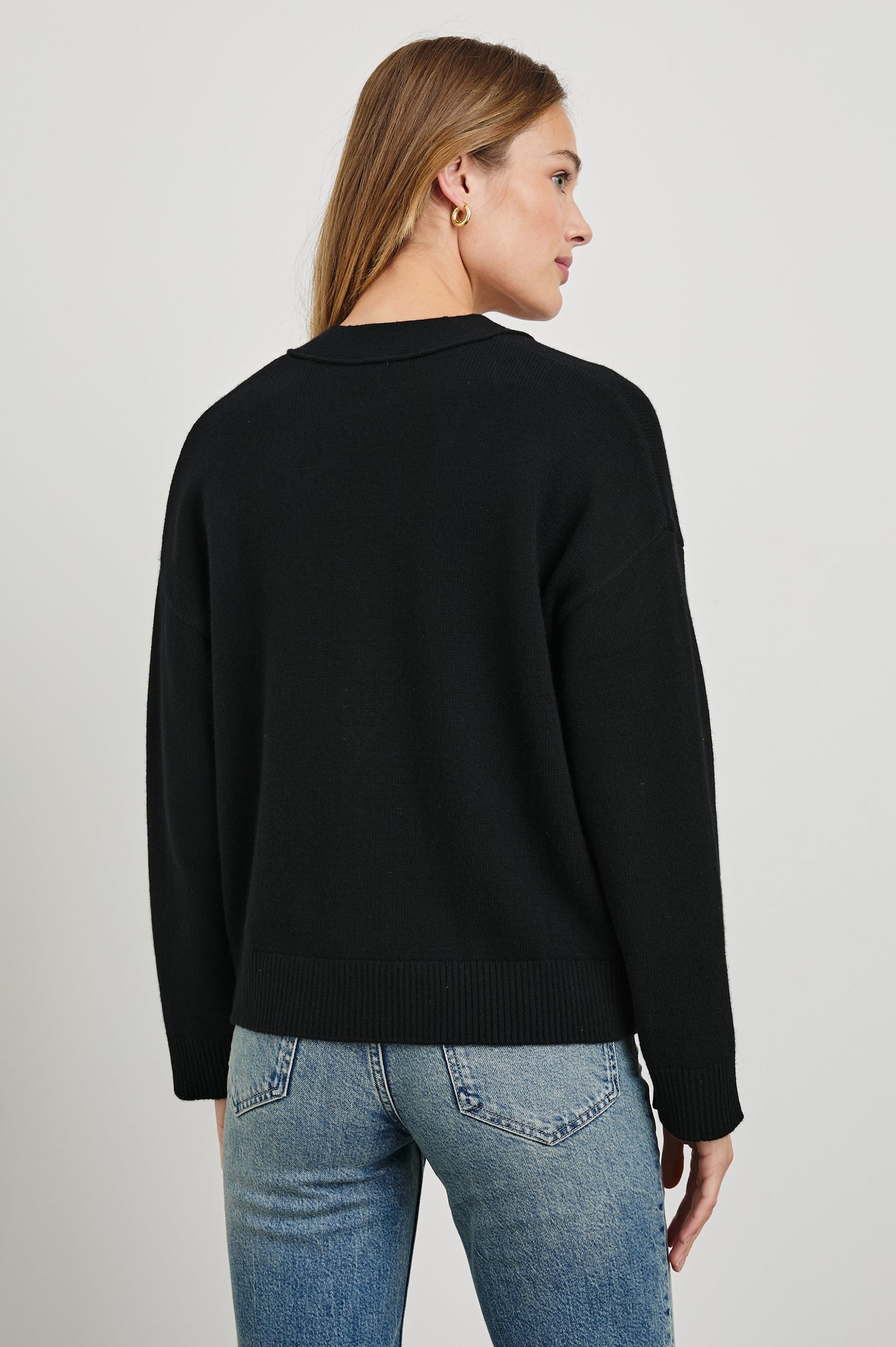 Lindi Long-Sleeve V Neck Cardigan with Three Button Closure, Two Front Patch Pockets and Ribbed Trim in Black Colorway - Back View Featured on Model