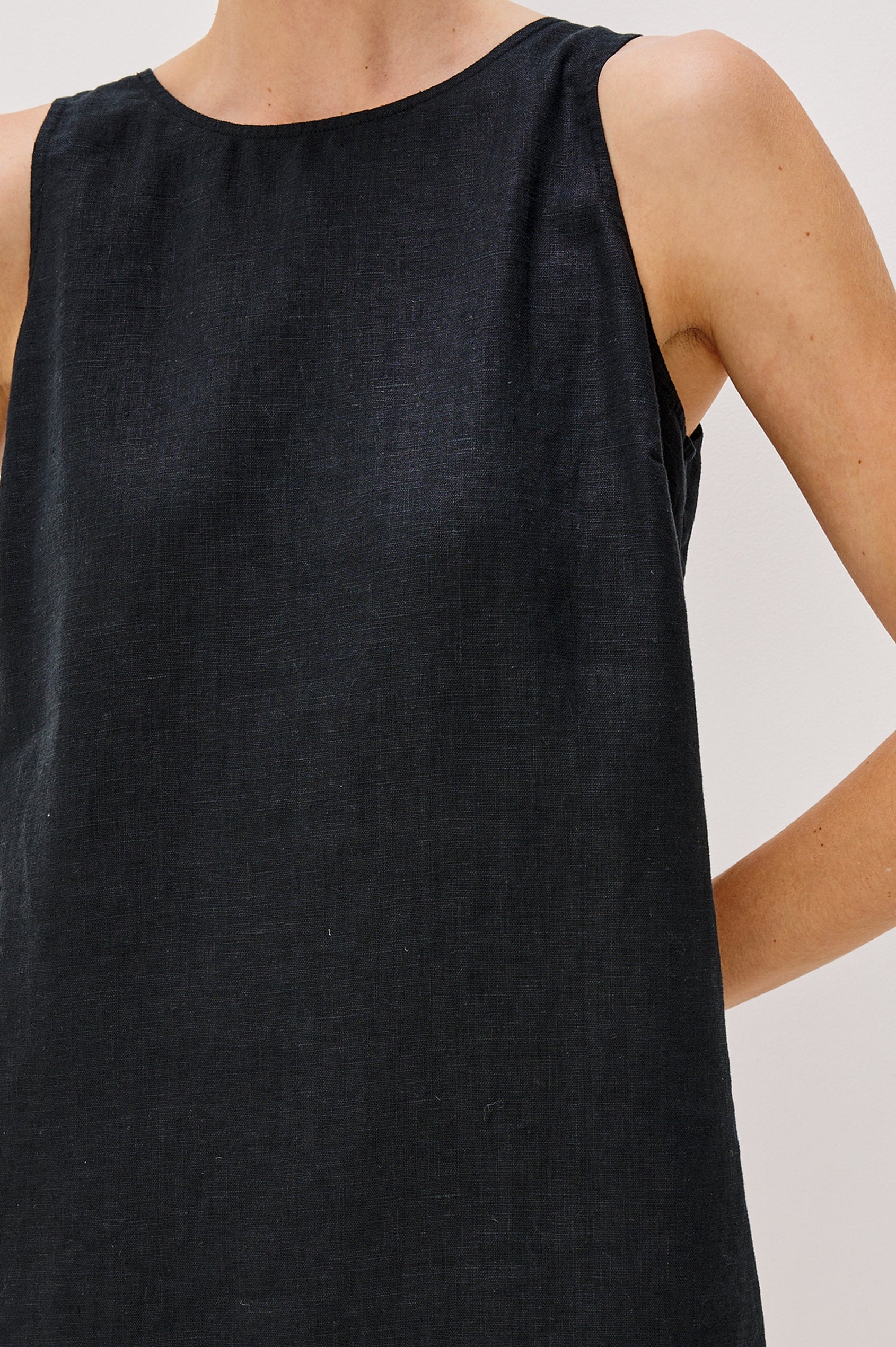 Lindsey Sleeveless Scoop Neck Mini Dress in Black Colorway. Front Detail View Shown on Model.