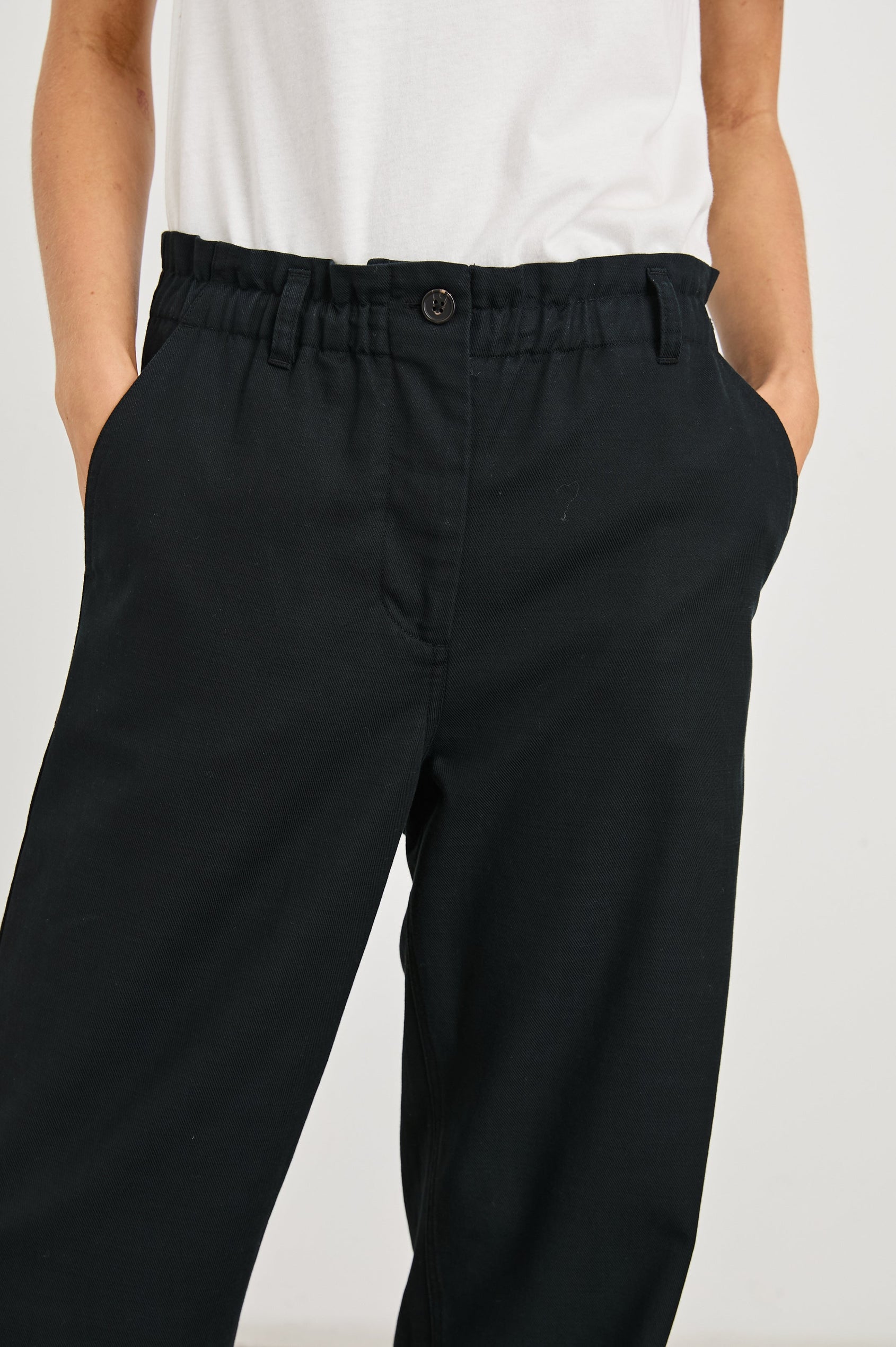 Lira Pants with a Paperbag Elastic Waist, Belt Loops, Two Front Pockets and Two Back Welt Pockets in Black Colorway - Front View Featured on Model 