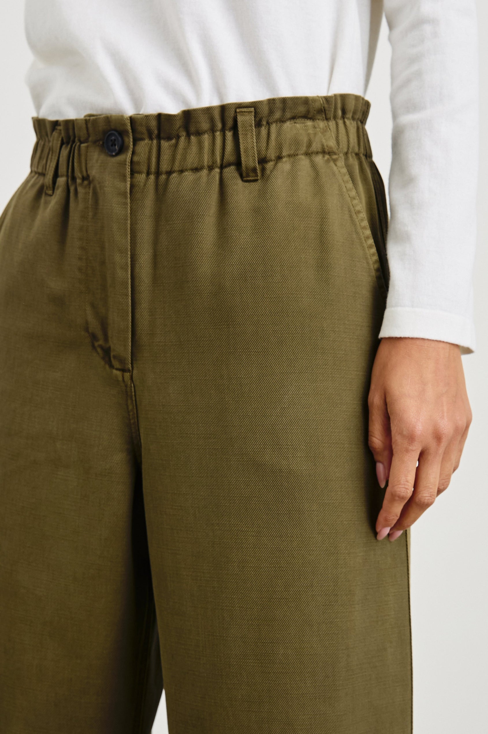 Lira Pants with a Paperbag Elastic Waist, Belt Loops, Two Front Pockets and Two Back Welt Pockets in Dark Olive Colorway - Front View Featured on Model 