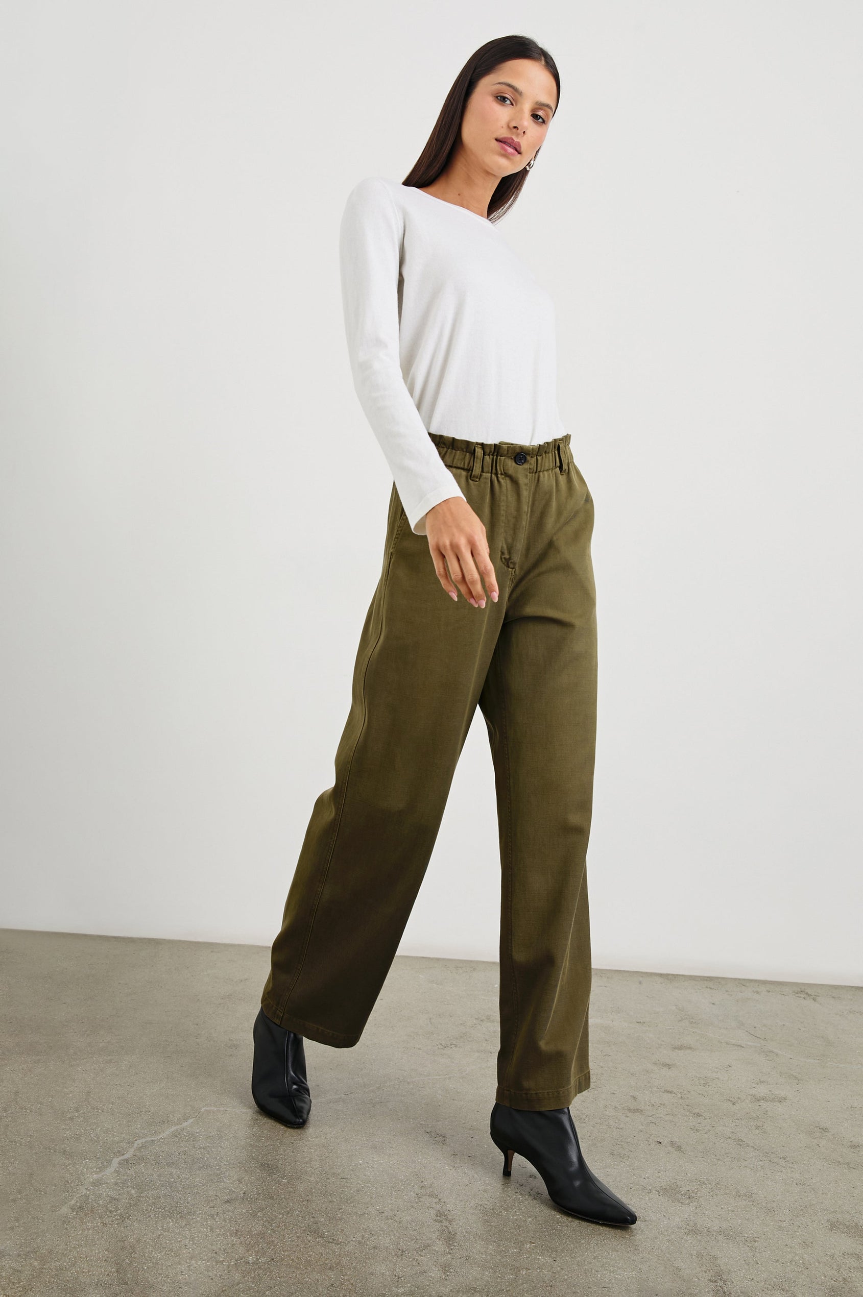 Lira Pants with a Paperbag Elastic Waist, Belt Loops, Two Front Pockets and Two Back Welt Pockets in Dark Olive Colorway - Front Full Body View Featured on Model 