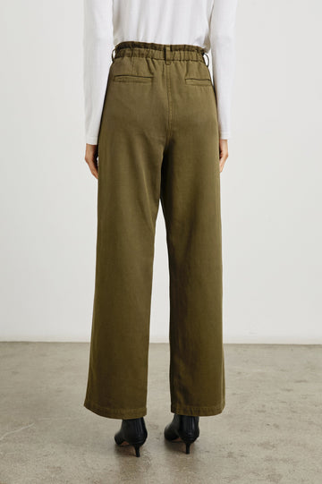 Lira Pants with a Paperbag Elastic Waist, Belt Loops, Two Front Pockets and Two Back Welt Pockets in Dark Olive Colorway - Back View Featured on Model 