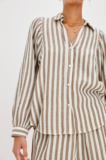 Lo V-Neck Collared Button Front Shirt with Long Sleeves and a Curved Hem in Brown and Cream Milos Stripe Colorway. Front View Shown on Model.