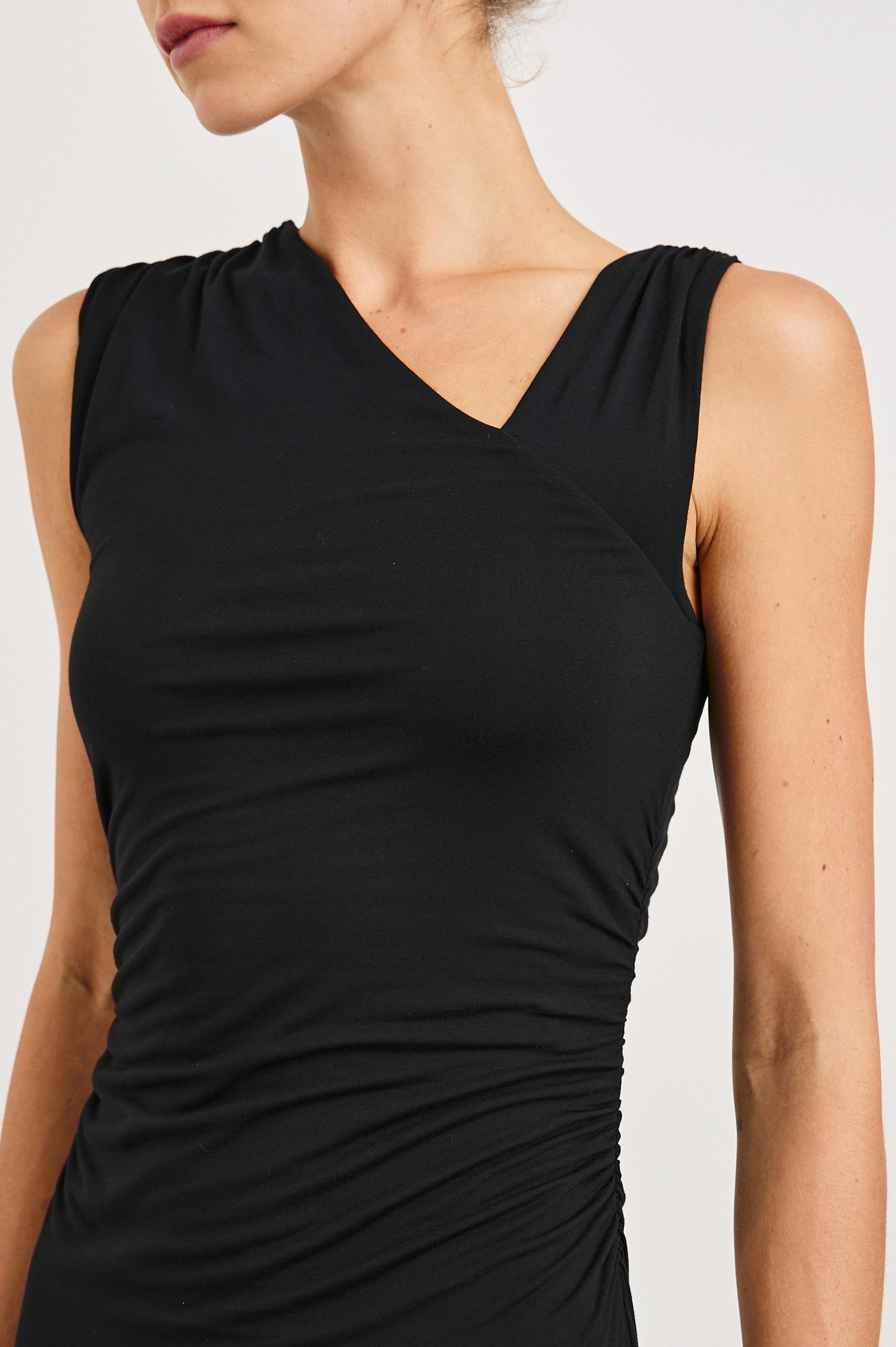 Lola Sleeveless Midi Dress with Ruching Along Both Bodice Sides, a Mid-Thigh Side Slit and an Asymmetrical Neckline in Black Onyx Colorway - Front View Featured on Model