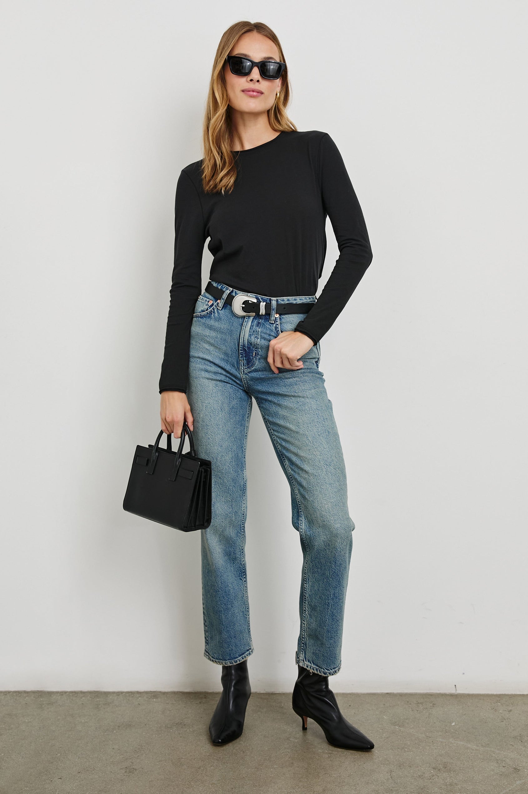 Long Sleeve Crew Neck T Shirt with Raw Hem, Collar and Cuffs in Black Colorway - Front Full Body View Featured on Model