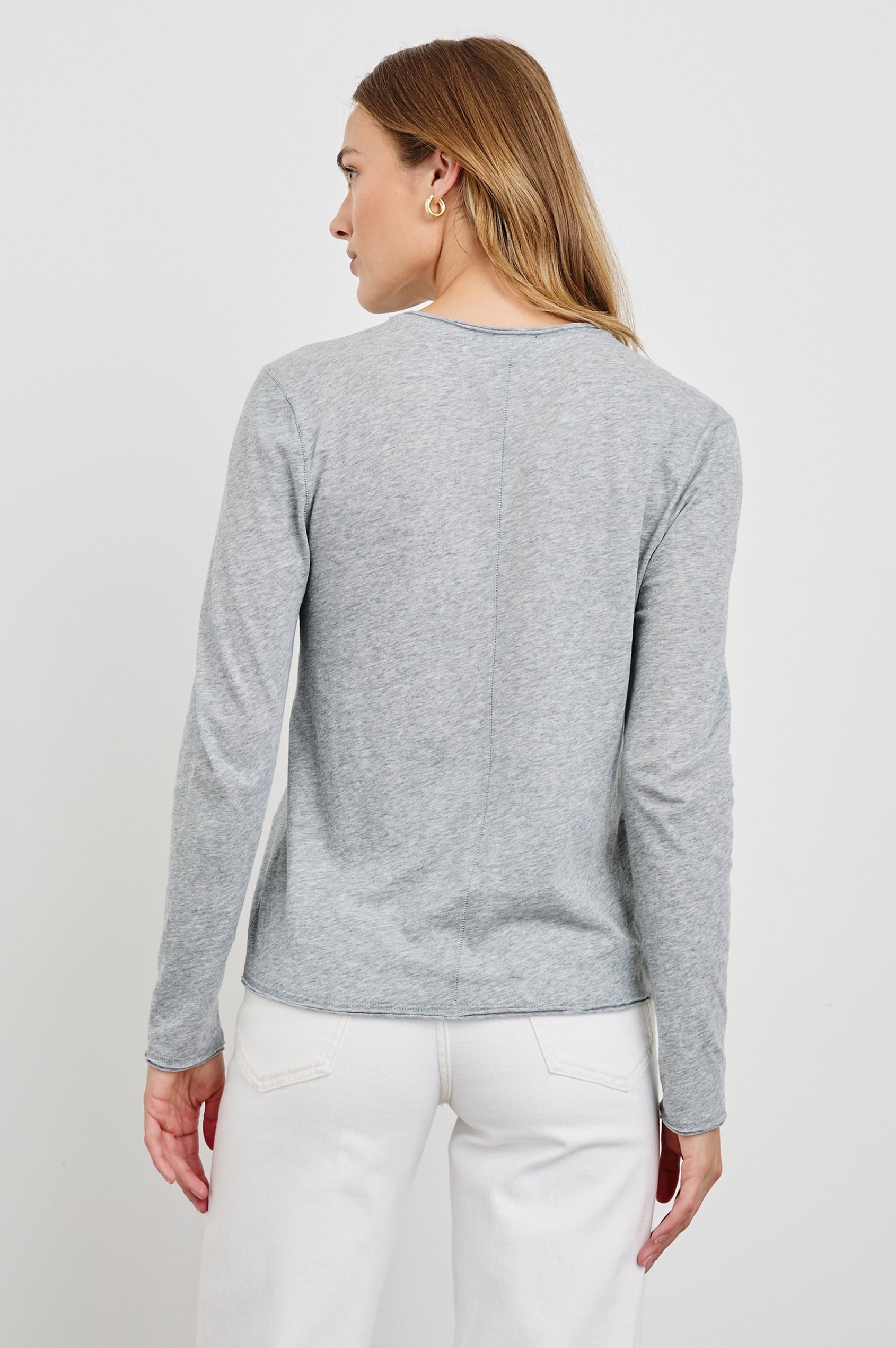 Long Sleeve Crew Neck T Shirt with Raw Hem, Collar and Cuffs in Heather Grey Colorway - Back View Featured on Model