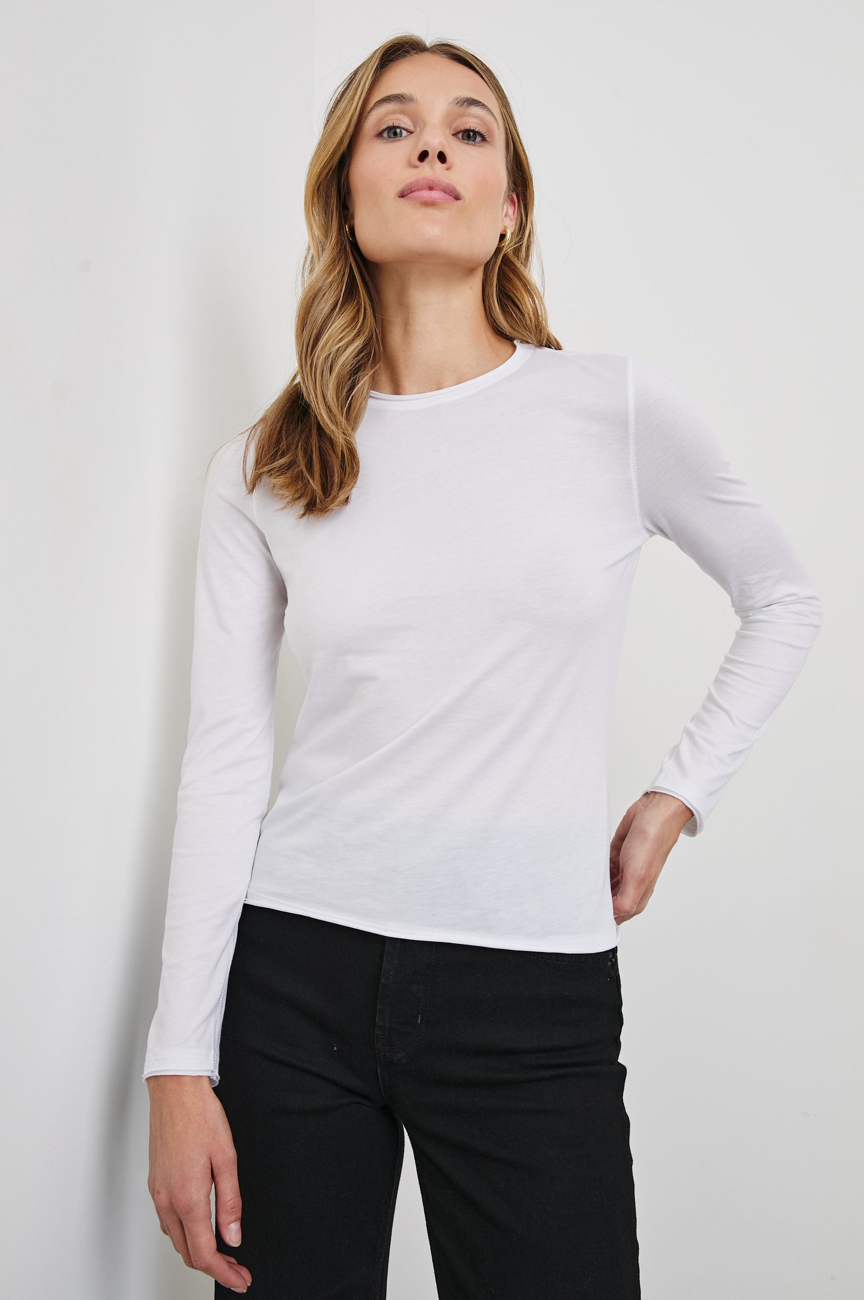 Long Sleeve Crew Neck T Shirt with Raw Hem, Collar and Cuffs in White Colorway - Front View Featured on Model