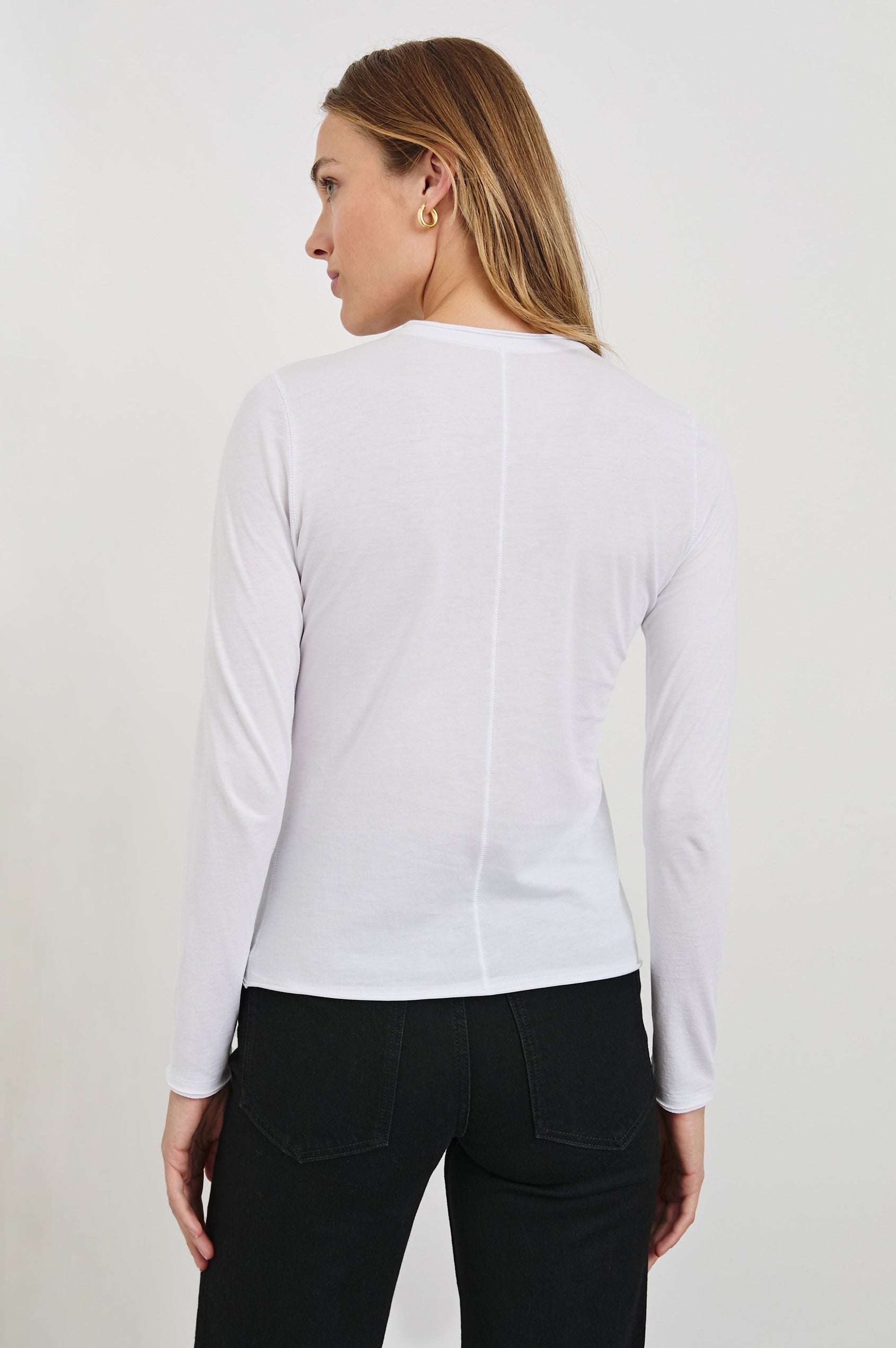Long Sleeve Crew Neck T Shirt with Raw Hem, Collar and Cuffs in White Colorway - Back View Featured on Model