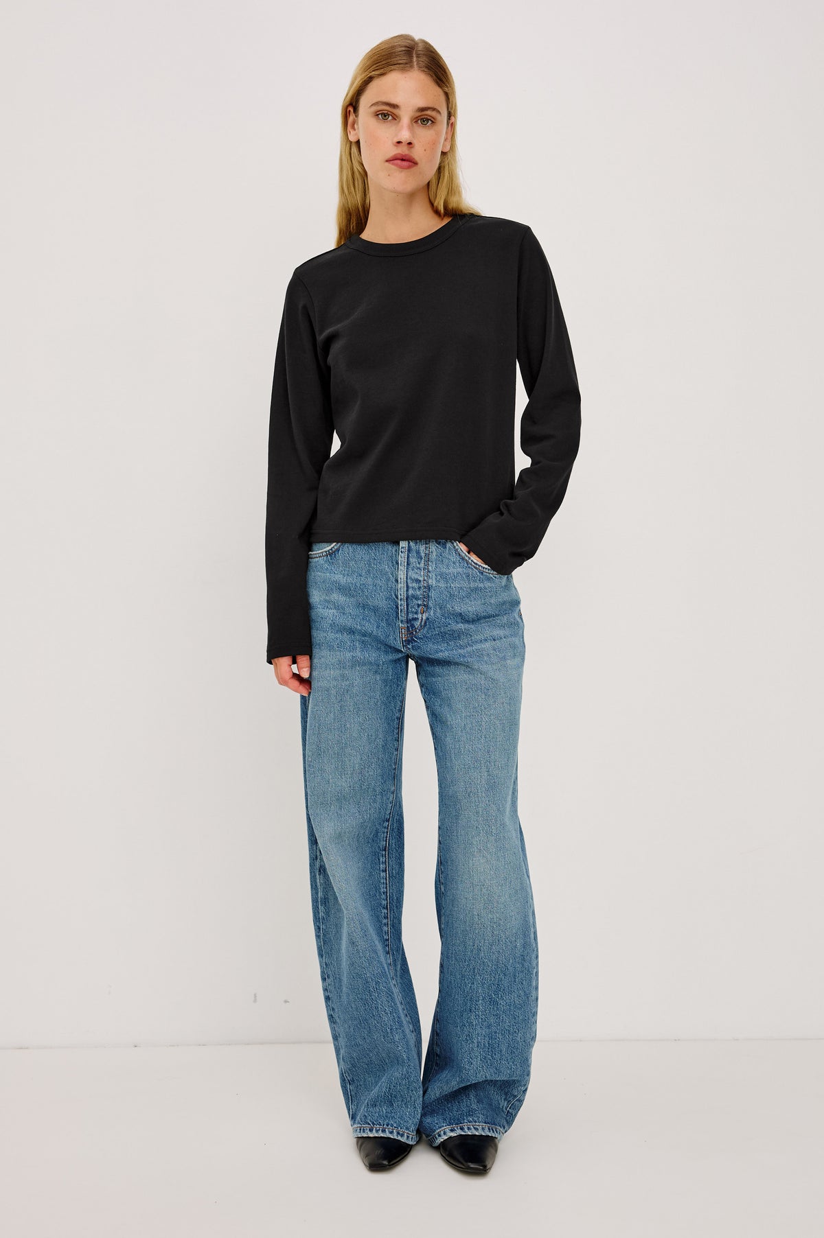 Long Sleeve Girlfriend Tee in Midweight Pleated Jersey in Slightly Boxy Cropped Fit With Crew Neckline in Black Colorway - Front Full Body View Featured on Model.