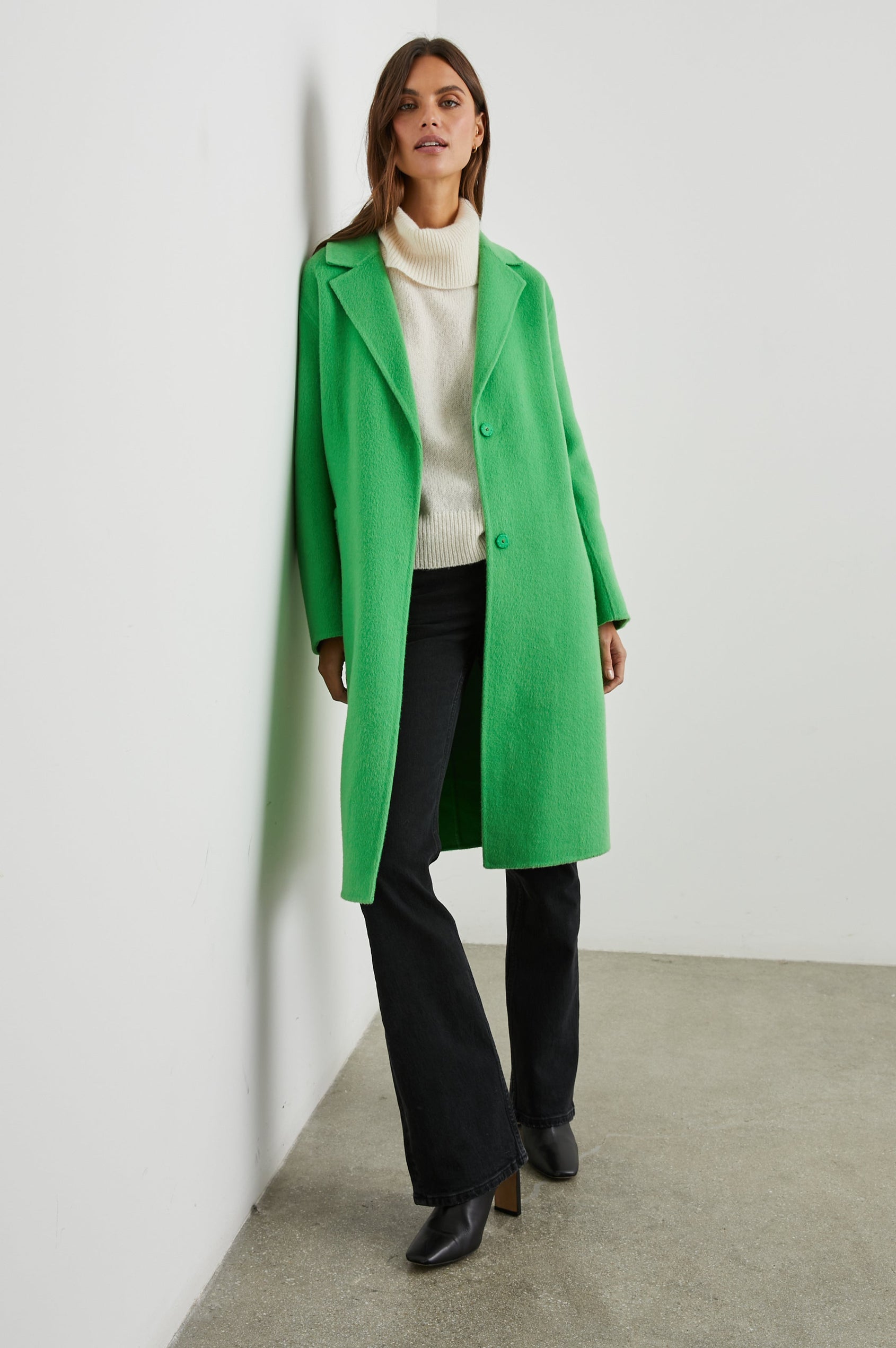 Lore Knee-Length Coat with Two Button Closure, Notched Lapels and Two Front Pockets in Green Apple Colorway - Front Full Body View Featured on Model