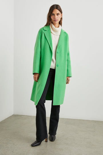 Lore Knee-Length Coat with Two Button Closure, Notched Lapels and Two Front Pockets in Green Apple Colorway - Front Full Body View Featured on Model