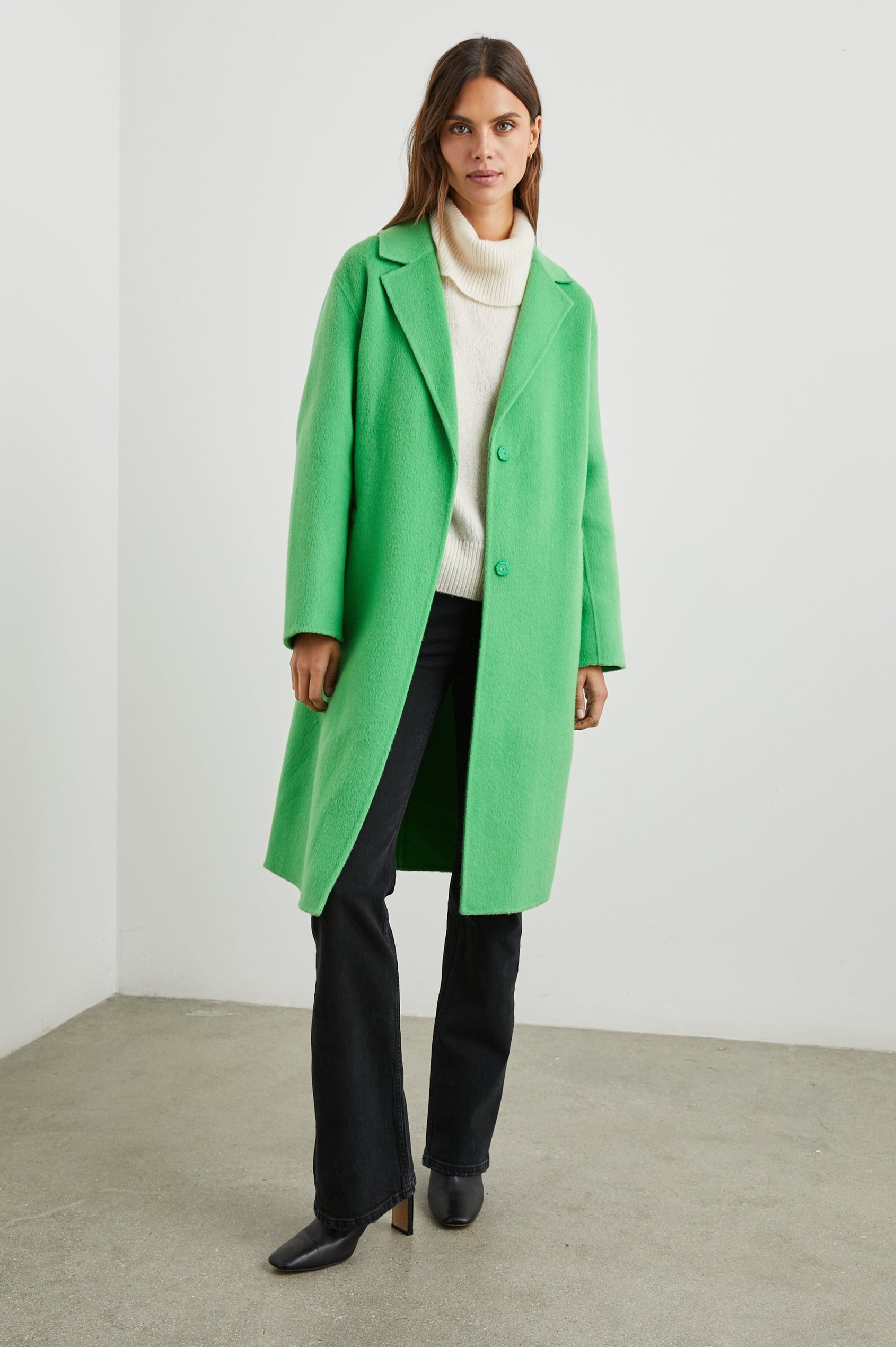 Lore Knee-Length Coat with Two Button Closure, Notched Lapels and Two Front Pockets in Green Apple Colorway - Front Full Body View Featured on Model