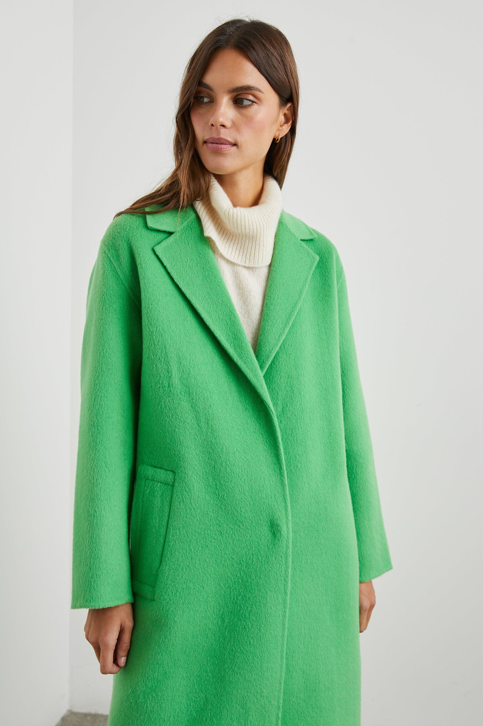 Lore Knee-Length Coat with Two Button Closure, Notched Lapels and Two Front Pockets in Green Apple Colorway - Front View Featured on Model