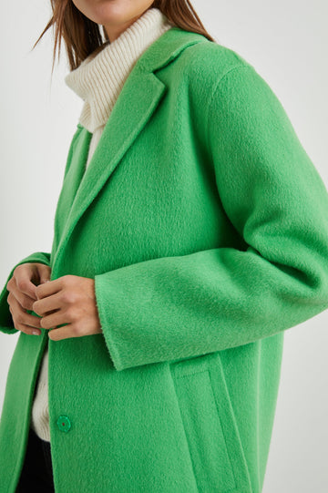 Lore Knee-Length Coat with Two Button Closure, Notched Lapels and Two Front Pockets in Green Apple Colorway - Front View Featured on Model