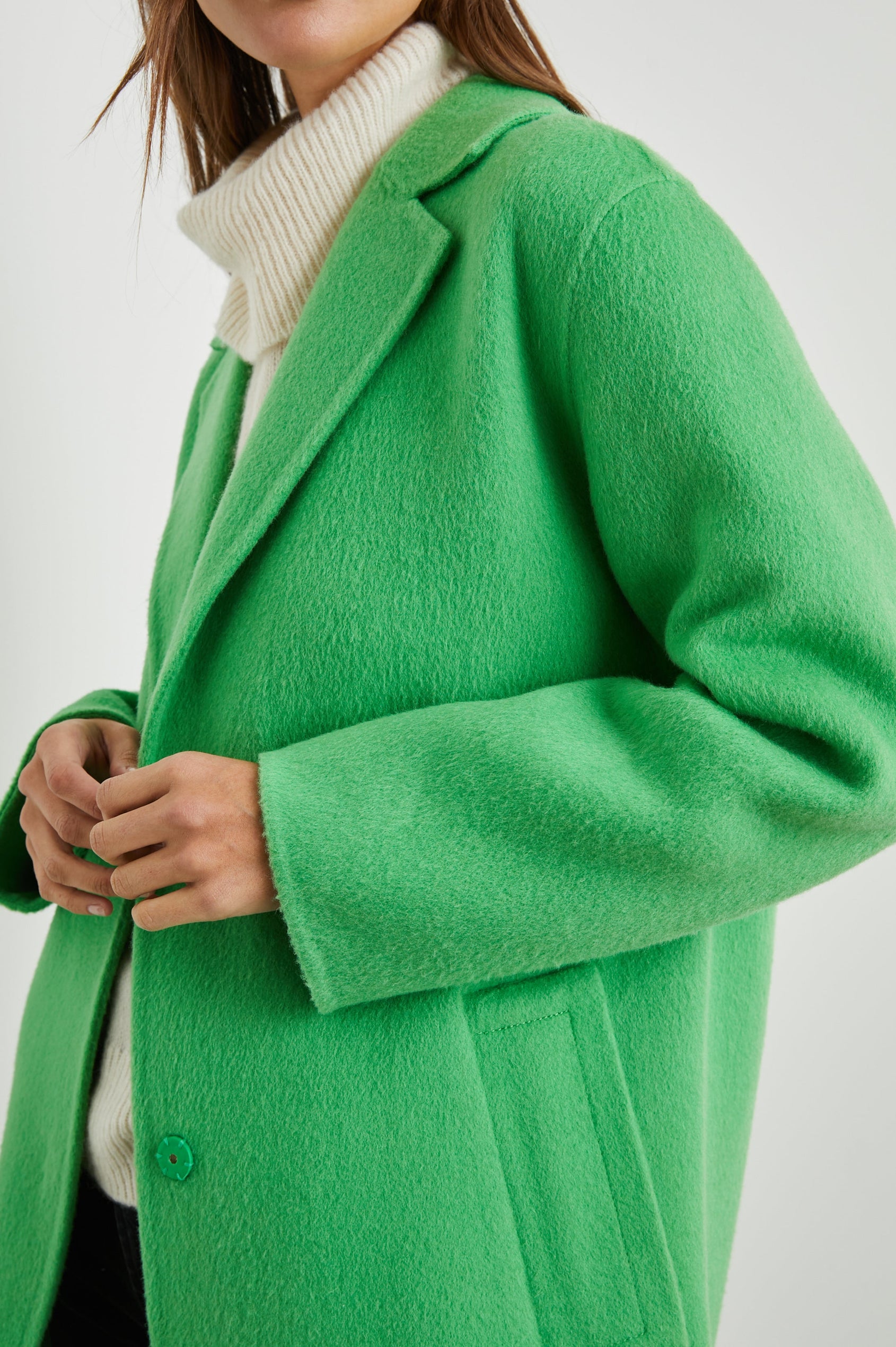 Lore Knee-Length Coat with Two Button Closure, Notched Lapels and Two Front Pockets in Green Apple Colorway - Front View Featured on Model